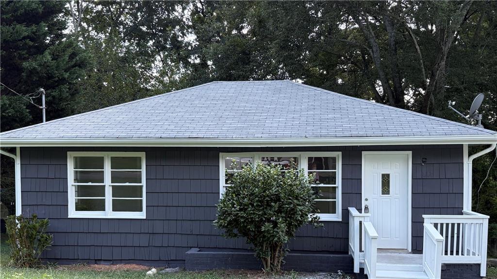 Charming bungalow just two miles from Marietta Square, nestled in an established tree-lined neighborhood and completely renovated inside and out. A bright, open living room features brand-new luxury vinyl flooring that flows seamlessly throughout the home, leading into a stylish kitchen with stainless steel appliances—including dishwasher, stove, and microwave—and a dedicated laundry closet. Two light-filled bedrooms provide the perfect retreat, while the expansive backyard offers endless possibilities with a spacious upper deck overlooking private wooded views, covered space below for storage or additional seating, and plenty of room for gardens, raised beds, a greenhouse, or even a chicken coop and run. This home qualifies for FHA, VA, and traditional conventional financing.