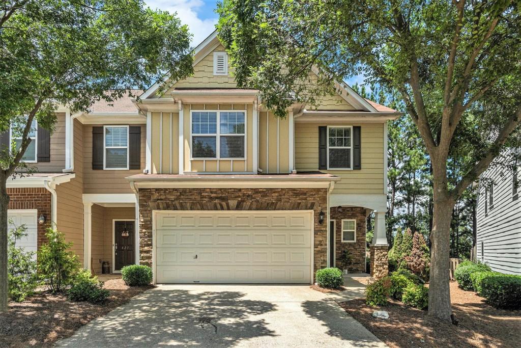 Welcome Home to this Light and Bright 3 Bedroom, 2.5 Bath End Unit Townhome in the Sought-After Mountain Brook Community Complete with Swim, Trails, and a Private Lake! The Open Concept Main Level Floorplan features a Two-Story Living Room with a Cozy Gas Fireplace, a Spacious Dining Area with Crown Molding and Wainscoting, and a Generous Kitchen with Stainless Steel Appliances, a Breakfast Bar, Wooden Shaker Cabinets, and a Walk In Pantry. A Convenient Half Bath on the Main adds function and flexibility. Upstairs, the Oversized Owner's Suite includes Trey Ceilings, a Luxurious Bath with a Soaking Tub, Separate Shower, Double Vanity Sinks, and an Expansive Walk-In Closet. Two Additional Bedrooms and a Full Bathroom offer plenty of space for family or guests. Fresh Interior Paint and Brand New Carpet make this one Truly Move-In Ready! Step outside to your Walk-Out Patio and Grassy Area Perfect for Grilling Out, Pets or a Private Garden. Enjoy Top-Tier Amenities like a Swimming Pool, Fishing Dock, Playground, and Miles of Walking & Hiking Trails. Tucked away in a Quiet Spot just off HWY 92 with Easy Access to 575 & 400, and just minutes from Downtown Roswell, Downtown Woodstock, Marietta, Shopping, Restaurants, and Entertainment This is the One You've Been Waiting For!
