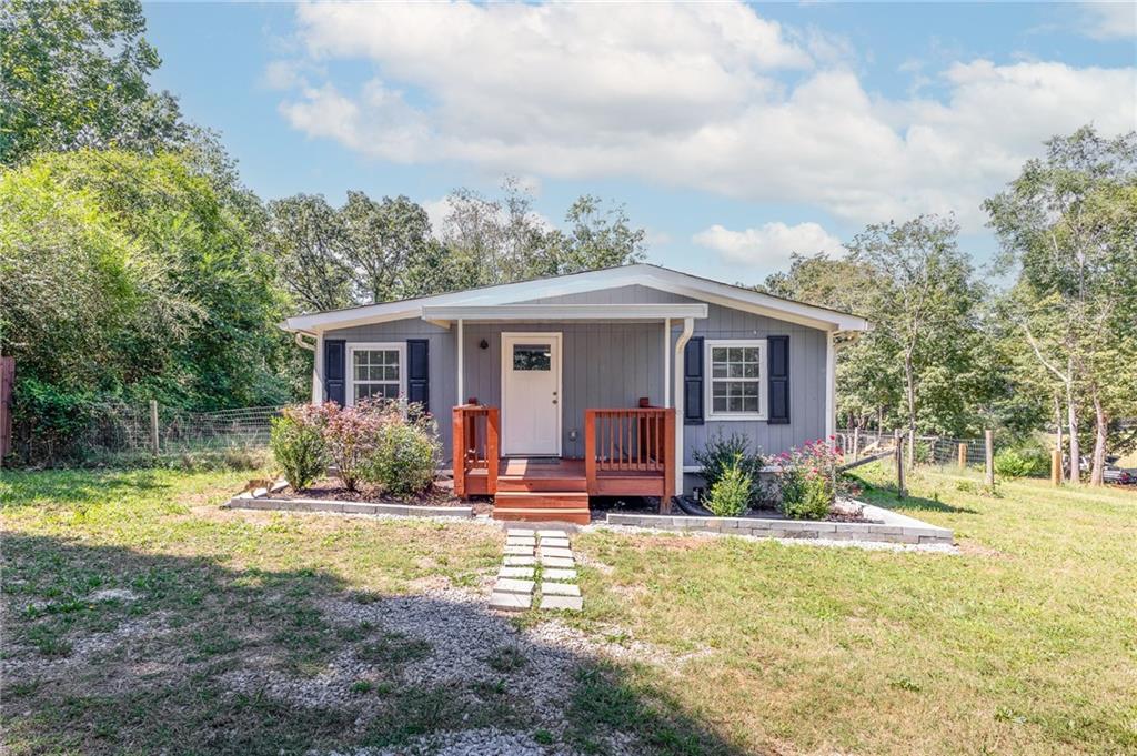 Charming two bedroom, two full bathroom cottage, combining character with modern updates. Originally built in 1930, this home was completely gutted to the studs in 2020 and remodeled, giving you peace of mind with modern systems and updates while still retaining its cottage charm. Enjoy your mornings on the front porch, relax on the back porch, or take advantage of the partially fenced yard with plenty of room to garden, play, or simply unwind.
Sitting on a spacious 1.14-acre level lot, this home is move-in ready and waiting for its next owner. Step inside to find an open, light-filled layout with kitchen featuring granite countertops — perfect for everyday living. Need storage? You’ll love the oversized 14’x28’ shed, ideal for tools, hobbies, or even a workshop.
Located in a quiet setting yet still convenient to Gainesville’s shopping, dining, and Lake Lanier, this property blends comfort, charm, and practicality — all on a beautiful acre-plus lot. Move right in and start enjoying your own piece of Gainesville!