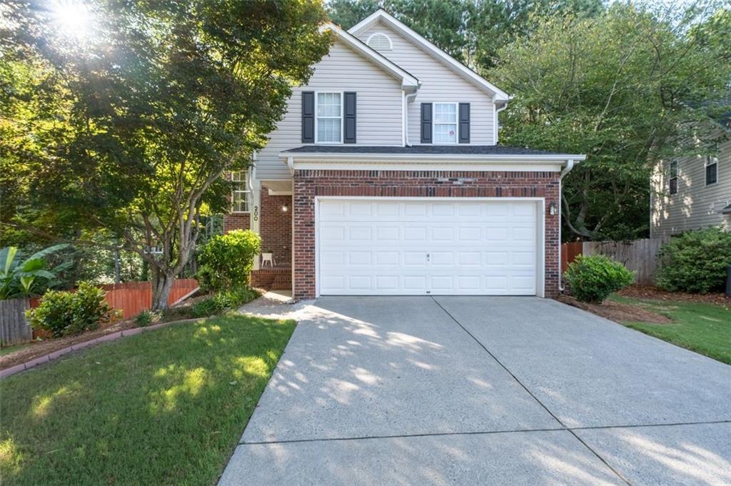 This beautifully maintained 3-bedroom, 2.5-bath home with finished basement, combines comfort, character, and convenience in one perfect package. Step into the two-story living room featuring a wood-burning fireplace. The open-concept layout flows effortlessly into a spacious eat-in kitchen, perfect for entertaining or everyday living. Upstairs, you'll find generously sized bedrooms and an updated primary bath that feels like a personal retreat. The finished basement offers additional flex space for a home office, gym, or media room — whatever fits your lifestyle. Outside, enjoy a cozy fire pit for cool evenings and with a built-in dog washing station on the back deck, making cleanup a breeze. Other highlights include a level driveway, epoxy-coated garage, low-maintenance living with front yard care included in the HOA, and neighborhood pool with a peaceful setting that feels tucked away while still close to everything Woodstock has to offer.