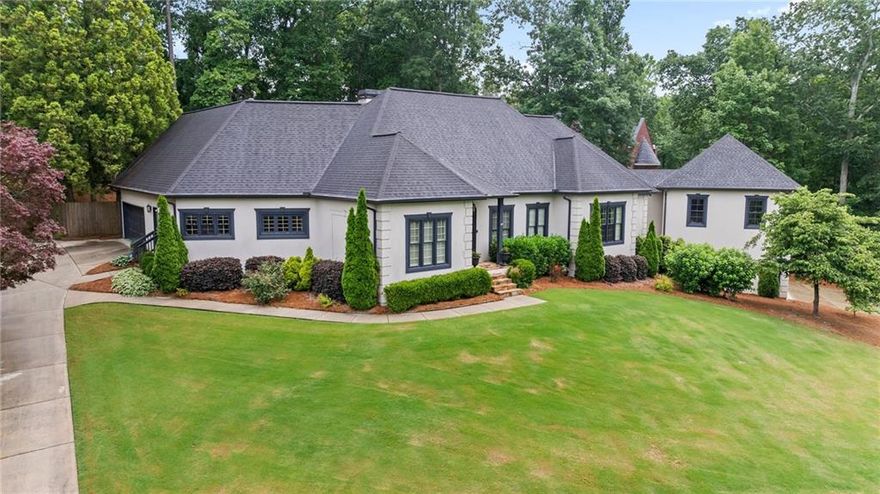 Perched atop a hill with breathtaking views and ultimate privacy, this one-of-a-kind estate offers the perfect blend of elegance, space, and story. Once owned by legendary Braves manager Bobby Cox during their World Series win, this home is not only beautiful, it's iconic. Step inside to a large, open floor plan designed for effortless entertaining and everyday luxury. The main level features a spacious primary suite, a private office, and seamless access to a backyard oasis complete with a walk-out pool, grilling deck, patio, and built-in gas fire pit. A rare find, this home includes two separate two-car garages and a major addition showcasing what can only be described as the world’s greatest closet, a must-see feature for anyone who appreciates elevated living. Upstairs, you’ll find three oversized guest bedrooms and a generous walk-in bonus room. The recently finished terrace level adds even more livable space with a full bedroom, bath, rec room, and wet bar, ideal for entertaining or hosting guests. Come experience this unforgettable home where luxury meets legacy.