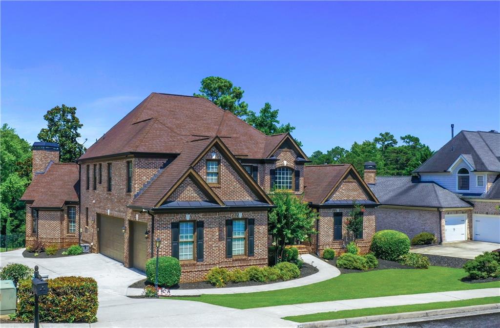 Enjoy Unbeatable views from Morning Coffee to Golden Hour - situated on one of Hamilton Mill’s Finest Golf Lots, the 13th Green in the coveted Glenaire Section! This Custom Built Traditional Home in the Mill Creek School Cluster checks all the boxes - 4 Side Brick, 3 Car Garage, Owners Suite on Main, Finished Terrace Level, and Neutral Paint throughout. Step thru the Double Iron Front Door into soaring ceilings in the Foyer, Great Room, and Keeping Room—where natural light pours in and a stunning floor-to-ceiling stone fireplace creates a warm, inviting focal point. The Custom Gourmet Kitchen opens effortlessly to the keeping room, eat in kitchen and around the corner, an oversized dining area, offering the perfect layout for Hosting year round! The Owners Suite on Main is a retreat all its own - featuring a private sitting area with fireplace, an updated spa-like bath, and a custom closet system. Upstairs, you’ll find three generously sized bedrooms and two full baths. Enjoy outdoor living from the oversized trex deck—partially covered for year-round use. And when it's time to entertain? Head downstairs to your Fully Finished Terrace Level—complete with a Home Theater, a Custom Wet Bar, a Spacious In-Law Suite with an Ensuite Bath, a Flex Room - perfect for a Home Office, Mini Gym or Playroom, and a generous unfinished storage space to keep everything tucked away. Enjoy the Unmatched Lifestyle Hamilton Mill offers with Two Resort-Style Pools, a Fitness Center, Tennis Courts, Pickleball Courts, Basketball and Volleyball Courts, a Stocked Lake, Playgrounds, and the Hamilton Mill Golf and Country Club Clubhouse. Conveniently located near Shopping, Dining, Parks, Lake Lanier, and I-85.