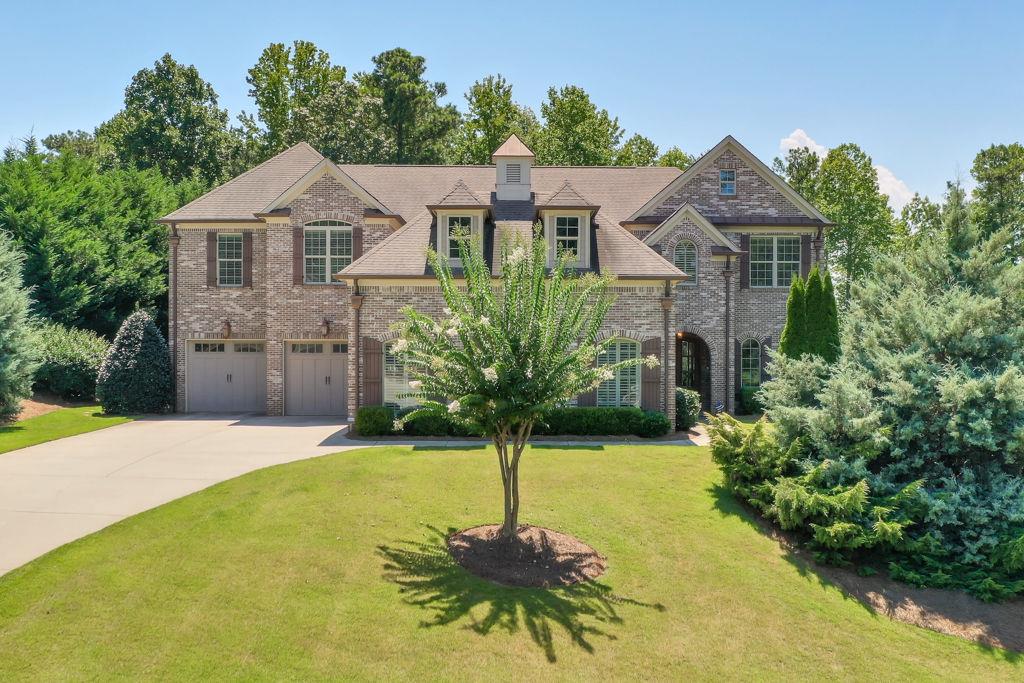 Exquisite Custom Built Estate a Prestigious Gated Community: Thoughtfully designed, this expansive 6-bedroom, 6.5-bathroom custom home offers refined living with the perfect blend of elegance, comfort, and privacy. Step inside to 14' soaring ceilings, Wide plank European white oak floors, and beautiful finishes throughout. The gourmet kitchen boasts Cambria Quartz countertops with a hidden walk-in pantry (wired for a 4th oven) and seamless flow into the spacious living area with fireplace. The main level also includes a private apartment with a full kitchen and separate entrance, ideal for an in-law suite or home business. The interior open air courtyard with a large chess set and garden accentuate the uniqueness of this amazing home. A bonus room with a wet bar upstairs provides flexible space for a media room, gym, or playroom. Retreat to the expansive primary suite, complete with sitting area, spa-like bath, and private fireplace ambiance. Outside is perfect for entertaining with seasonal lake views and outside brick fireplace. Additional features include: A Mudroom with massive Custom Cabinetry* TWO fully equipped laundry rooms (one on each floor)* Three car garage (Oversized main garage with custom cabinetry)*Commercial grade AC system* Intercom system throughout home*Two family rooms* Master bedroom with dedicated AC system*Dual tankless water heaters. Tile and marble in all bathrooms and showers* Beautiful seasonal lake and sunset views! This residence offers the perfect balance of tranquility, privacy and convenience.