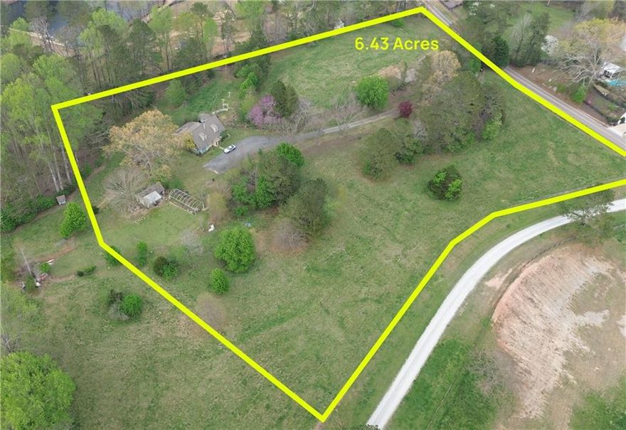 Discover an incredible opportunity to own 6.43 acres of prime land in the highly sought-after city of Alpharetta, right off Liberty Grove Road—all with the added benefit of lower Cherokee County taxes. Situated in the heart of Alpharetta's horse country, this expansive property offers endless possibilities for custom home builders or buyers looking to create their dream estate in a serene, private setting. This property boasts dual road frontage on Liberty Grove Road and Rivendell Lane, providing the potential for multiple access points and enhanced flexibility for development. The elevated hilltop setting offers stunning views, making it an ideal backdrop for a luxury home. An existing home sits on the property, but the true value lies in the land—offering a blank canvas for a custom estate or future development. The property includes a small cemetery (0.16 acres), with easement rights retained by the previous owners for future access and maintenance. Enjoy the perfect blend of privacy and convenience, with easy access to top-rated schools, shopping, dining, and major highways. Whether you're envisioning a private estate, family compound, or signature build, this property offers the space and potential to bring your vision to life.