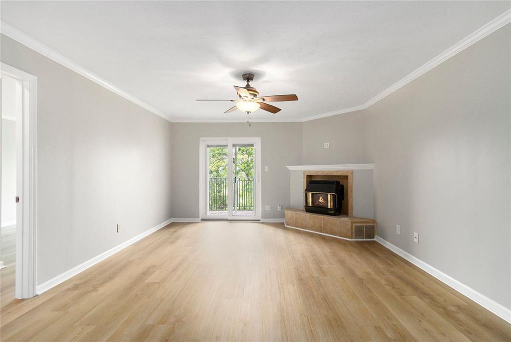 Exceptional Move-In Ready Corner Unit with Fresh Updates & Unmatched City Views! Welcome to a beautifully refreshed third-floor corner unit offering sweeping views of Midtown and Lindbergh from both bedrooms and a private balcony—ideal for sipping your morning coffee or winding down after a long day. Thoughtfully designed, this home delivers exceptional privacy and peaceful living, all within a vibrant, gated community. Recently updated from top to bottom, this home is truly move-in ready. Fresh interior paint covers every wall, trim, door, and select ceilings, while brand-new flooring throughout enhances the home’s modern appeal. Stylish new light fixtures brighten the space, and recent upgrades including a new range, furnace, AC coil, backsplash, and a new water heater offer both comfort and confidence in your investment. Step into the inviting family room, where a cozy fireplace anchors the space and creates the perfect setting for relaxing evenings. The kitchen is both stylish and functional, featuring granite countertops, stainless steel appliances, a glass tile backsplash, stained cabinetry, and a convenient breakfast bar. Luxury vinyl plank floors flow through the main living areas, leading to a dedicated dining space ideal for entertaining. The primary suite features a generous closet and a private marble bath with a granite-top vanity. The secondary bedroom includes a custom closet system and easy access to a beautifully appointed guest bath. This home includes one assigned parking space and access to resort-style amenities: lush green spaces, a pet-friendly area, sparkling swimming pool, fitness center, grilling stations, and ample guest parking. Nestled in the heart of Atlanta, you'll enjoy unbeatable access to shopping, dining, and commuter routes. Don’t miss your chance to own this rare gem. Schedule your private tour today and experience the perfect blend of comfort, style, and city living.