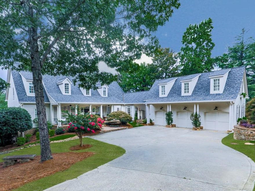 Welcome to 211 Morning Mist Way, a meticulously crafted builder’s personal residence, now available for the first time! Situated in the serene locale of Woodstock, Georgia, this impressive Southern Living property offers a harmonious blend of luxury and comfort across its six-bedroom, five-full, and two-half bathroom layout. Upon entering the home, you will be greeted by a residence rich in custom upgrades and high-quality construction. The recently remodeled main level boasts a two-story foyer featuring newly refinished hardwood flooring, an expansive dining room, a spacious living room accommodating a baby grand piano and a concrete fireplace with gas logs. The kitchen is equipped with a substantial island ideal for entertaining, concrete countertops, a Wolf range top, a SubZero refrigerator, a Bosch dishwasher, a warming drawer, a Kohler farm sink, floating shelves, limestone flooring, a custom walk-in pantry, and a large breakfast area adjacent to a sunroom perfect for morning coffee. The two-story keeping room features a floor-to-ceiling stacked stone fireplace, tongue-and-groove ceiling, and motorized custom linen blackout window treatments. Additionally, the main level includes the primary suite with new hardwood flooring, custom motorized blackout window treatments overlooking an exceptional view of the sixth green. A recently remodeled en-suite bathroom incorporates limestone flooring, shiplapped walls, a Kohler soaking tub, and a custom frameless shower. The second level comprises three newly carpeted bedrooms with two bathrooms and an additional living room/loft area, which is particularly suitable for teenagers. The terrace level design boasts soaring ceilings, an expansive fireplace, custom woodwork, a SubZero refrigerator, wine cooler, ice maker, double Fisher & Paykel DishDrawers, and a walk-in wine cellar with ample storage capacity for numerous bottles of wine, secured by iron doors. Complementary rooms include an office, a pool room, a workout area, a children’s playroom with a full bath, and a half-bath with a custom vanity. Furthermore, the residence incorporates custom lighting, motion-activated switches, and built-in speakers, elevating both the aesthetic and audio-visual experience. The detached, oversized three-car garage boasts new epoxy-coated flooring, an electric heater, a work sink, and can accommodate oversized vehicles. Above, there is a charming one-bedroom, one-bathroom cottage with a fully equipped kitchen, washer/dryer combo, and a private entrance. This exquisite property is situated on a prime golf course lot, boasting a spacious front porch and a charming covered breezeway connecting the home and garage. The fenced backyard is ideally suited for a pool, while the cozy cobblestone patio off the terrace level provides a serene ambiance. The expansive back deck, featuring Ipe decking, a gas grill connection, iron pickets, and entrances from the living room, keeping room, and master suite, is perfect for hosting family gatherings. Every aspect of this home has been meticulously designed to maximize enjoyment and functionality. The Towne Lake Hills community provides residents with a range of amenities, including tennis courts, two swimming pools, a gymnasium, a playground, a clubhouse, a restaurant, and an optional golf club membership.