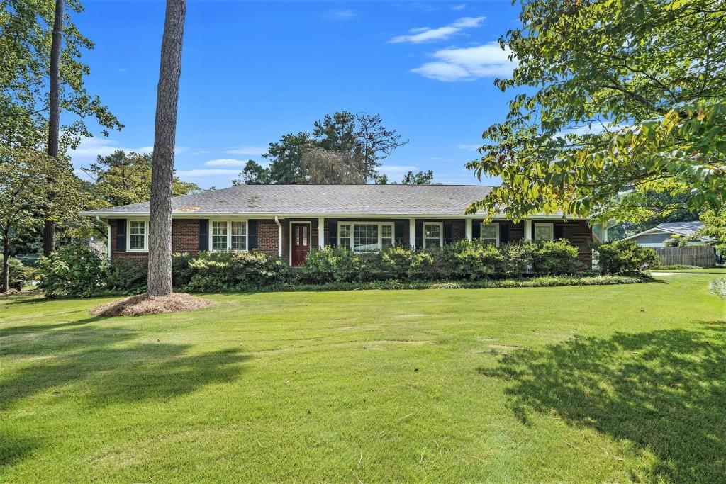 Welcome Home to this Stylish Brick Ranch with Basement Flex Space in the Heart of East Cobb! Nestled in the Highly Sought-After Stratford Community, this residence offers the Ideal Combination of Modern Comfort and Timeless Charm. Surrounded by Mature Trees and a Friendly Swim & Tennis Neighborhood, you'll find yourself perfectly positioned between Convenience and Community. The curb appeal abounds with a Corner Lot, large Flat Grassy Front Yard, and lovely landscaping. Head inside to the Formal Living Room that can serve as a versatile Flex Space, highlighted by Big Windows with Custom Wooden Shutters, Hardwood Floors, and Glass French Doors opening to the Formal Dining Room. Perfect for Entertaining and Making Memories. The Dining Room flows into the Kitchen featuring White Cabinets, and Stainless Steel Appliances. The Fireside Living Room boasts a door to the Private Large Deck an ideal spot for Al Fresco Dining overlooking the Massive Backyard. The Primary Bedroom on Main includes an Ensuite Bathroom with Shower, while Two Additional Bedrooms share a Hall Full Bathroom. The Daylight Basement is a True Gem perfect for a Playroom, Home Office, Gym, or Media Space. Step outside to the Private Fenced Backyard with Deck and Storage Shed. With plenty of space for Play, Gardening, or Weekend Grilling, it's designed for everyday living. A Two-Car Garage adds Extra Storage and Convenience. Living in Stratford means more than just a home it's a Lifestyle. Enjoy Optional Swim & Tennis Amenities, plus nearby Terrell Mill Park with Playground, Sports Fields, Pickleball, and Tennis Courts. With Quick Access to I-75, I-285, Sandy Springs, and Downtown Atlanta, you're connected to everything while enjoying the serenity of East Cobb living. Enjoy the Space, Flexibility, and Sense of Community Stratford is Known For. This East Cobb Ranch is Ready to Welcome You Home!