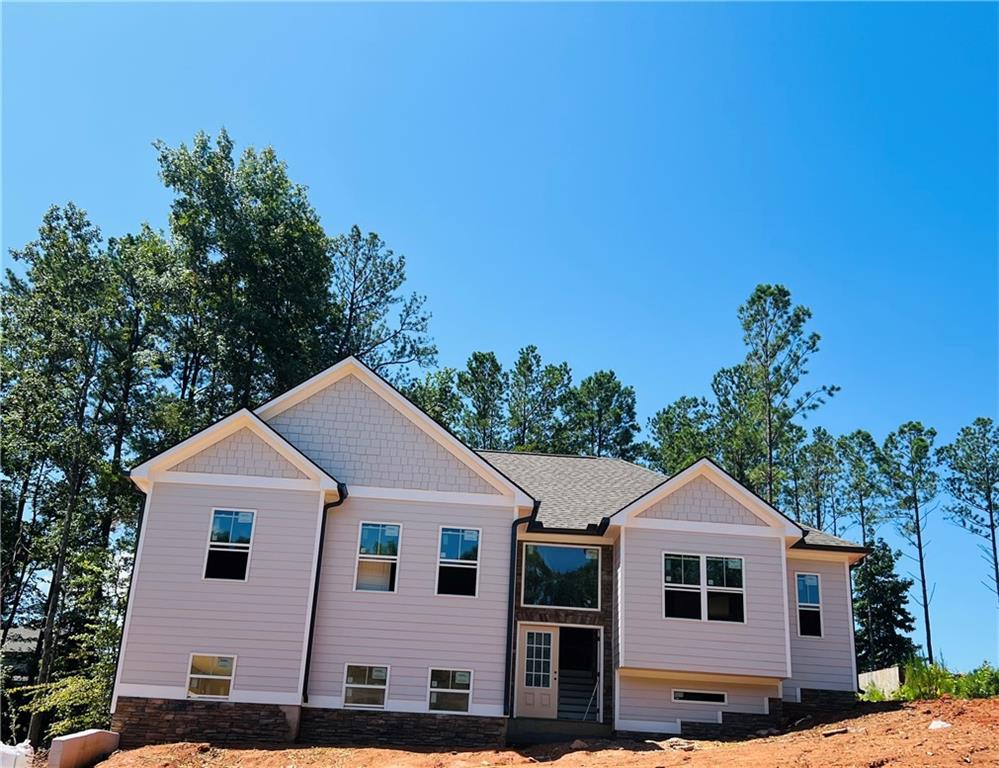 STUNNING NEW CONSTRUCTION SPLIT FOYER HOME! Welcome to Falls Grove by Frank Betz. This beautifully crafted 3 bedroom 3 bath home offers modern elegance and thoughtful design on a serene, wooded half acre lot. Enjoy open-concept floor plan with eat- in chef's kitchen equipped with quartz countertops, stainless appliances and more!! Spacious dining room has custom craftsman moulding that opens to large family room with soaring vaulted ceiling and gorgeous stacked stone fireplace. Oversized owner's suite includes a private sitting area and luxurious spa bath with premium finishes. Two additional bedrooms and full bath complete the main floor. The finished lower level offers versatile flex space and full bath - ideal for home office, guest suite, or recreation area. Don't miss this perfect blend of comfort, style and nature.