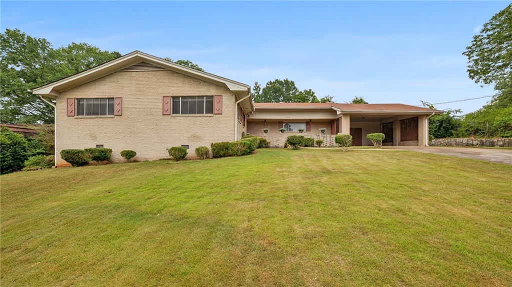 The PERFECT single-story layout with 1960s character on .5 acres! This L-shaped brick ranch features 3 bedrooms, 2 bathrooms, and laundry all on one wing, with a privacy door leading to the entertaining area in the other half. In absolute pristine condition, this home is perfect for those craving midcentury charm! There are vintage exterior light fixtures above the front courtyard, a fabulous kitchen with original cabinets and sink that overlooks the backyard, and gorgeous hardwoods throughout. As you enter the foyer with double coat closets, you're greeted with a designer's dream – ample space to customize with your personal touches. The den features an oversized fireplace spanning the entire back wall, with access to the patio and original brick barbeque area! The separate dining area is ready for entertaining and connects to a second living space. All 3 bedrooms have hardwoods and large windows, allowing an abundance of natural light. The primary suite features a private bath with original blue tile. Situated near parks and a lake in the quiet Churchill Downs neighborhood you don't want to miss this cozy charmer!