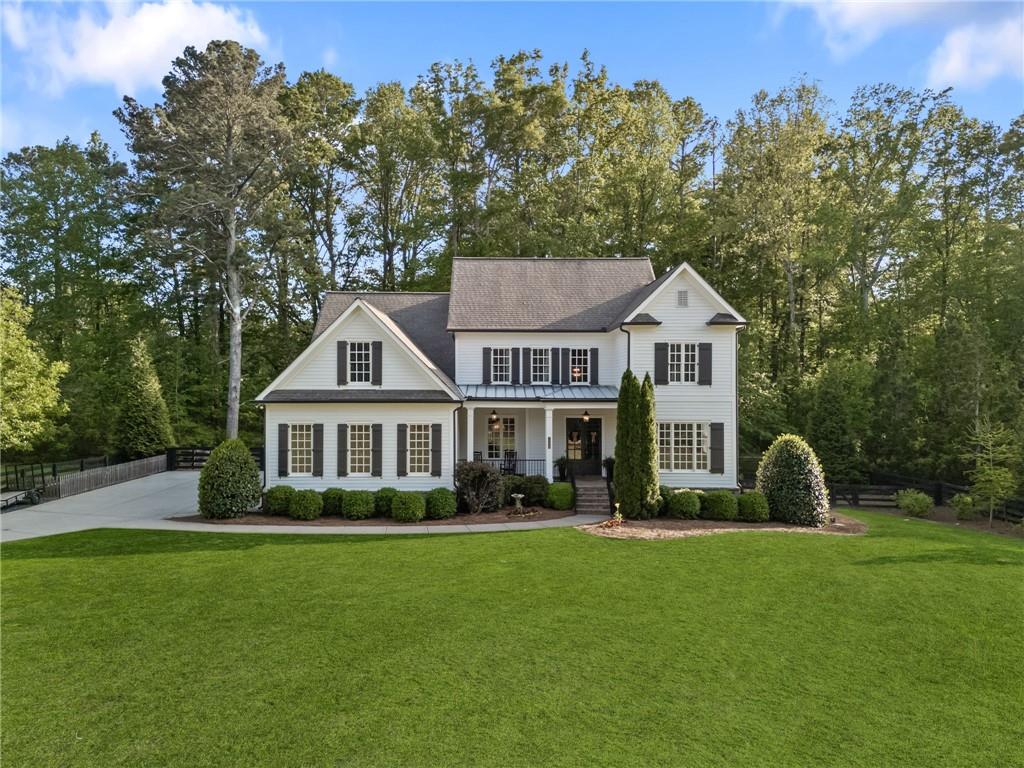 Nestled on one acre in a private, three home enclave, this modern farmhouse provides a welcoming atmosphere with an open-concept layout, perfect for entertaining. The spacious kitchen and large pantry will give you plenty of room to cook and host gatherings, and you will have room for everyone with 6 bedrooms and 6.5 bathrooms. The primary bedroom is located on the main floor - with brand new hardwood floors - and a large en-suite. Upstairs, you'll find four additional bedrooms and three bathrooms, along with roughly 1000 square feet of unfinished walk in attic space. On the terrace level, you'll find a bedroom and bathroom, office, gym or school room, living room, and theatre. Step outside to your own backyard retreat, where you'll find a refreshing saltwater pool and relaxing spa. Top-rated Milton schools, convenient access to shopping and dining, and a tranquil setting make this your dream come true. All new hardwoods on main and paint inside and out make this home better than new!