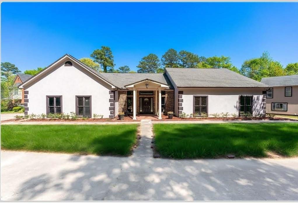 Two Homes, One Unmatched Estate! Welcome to a rare and refined estate — nearly 3 pristine acres at the end of a quiet cul-de-sac in one of the area’s most prestigious communities. From the moment you pass through the newly installed automatic gated entry, you'll feel the unmatched privacy, sophistication, and grandeur that set this property apart. Step inside the main residence and be immediately captivated by the soaring vaulted ceilings and striking fireplace in the expansive family room. A beautiful combination of brick and custom wood mantel anchors the space, while a built-in wet bar creates the perfect setting for entertaining guests in true luxury. Flowing seamlessly from the heart of the home, the formal dining room is an entertainer’s dream—gracious in size and crowned with a dazzling chandelier, ideal for hosting elegant dinners and celebrations. The chef’s kitchen is both beautiful and functional, featuring gleaming granite countertops, a professional-grade double oven, and an oversized island that invites connection—whether preparing a quiet meal or entertaining on a grand scale. Retreat to the private primary ensuite, a true sanctuary designed for rest and rejuvenation. A double-sided fireplace adds warmth and ambiance, enjoyed from both the bedroom and the spa-like bath. Soak away the day in the luxurious tub while gazing into the flickering fire—this is everyday indulgence, elevated. Beyond the main home lies one of the estate’s most exceptional features: a fully detached, two-story secondary residence. Perfect for multigenerational living, a long-term guest retreat, or even as a private income-producing rental, this secondary home offers both independence and flexibility without sacrificing style or comfort. Whether used as a guest house, private office suite, or creative studio, it expands the estate’s versatility in meaningful and luxurious ways. Also on the grounds, a charming barn structure offers even more potential—ready to be transformed into an entertainment retreat, workshop, or additional guest quarters. All of this is just moments from premier shopping, dining, and entertainment at the Mall of Georgia, yet quietly tucked away in your own private paradise. This is more than a home—it's a lifestyle of luxury, comfort, and distinction, with the added value of a truly rare secondary residence. Schedule your private tour today and experience this extraordinary opportunity for yourself.