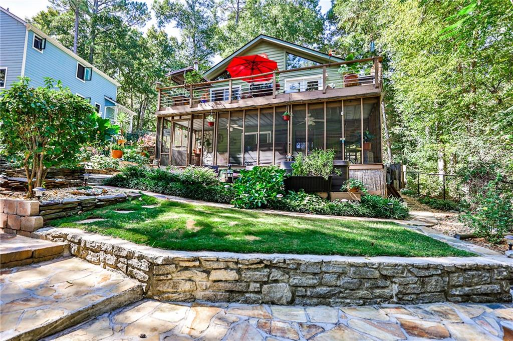 Lake life awaits at 572 Lake Drive in Snellville’s desirable private Norris Lake community. This charming 2-bedroom, 2-bath home sits on a 0.4600-acre lot and offers direct access to a private lake right in your backyard, creating a rare opportunity to enjoy a true lakeside oasis just 45 minutes from Downtown Atlanta and 15 minutes from Downtown Snellville. With its blend of natural beauty, outdoor recreation, and everyday convenience, this property offers the best of both worlds. Designed for lake life, this property features multiple outdoor spaces that maximize enjoyment and entertaining. An expansive deck off the living and dining room is perfect for grilling and hosting gatherings with friends and family. From the screened-in porch off the basement, you can relax while enjoying fresh air and lake views in any weather. Gather around the lakeside fire pit or entertain on the terraced backyard right by the water—with a private dock and boat slip, it’s easy to head out for boating, fishing, or simply floating. This home truly allows you to live, relax, and entertain right on the lake. Inside, you’ll find an inviting open-concept layout where the kitchen, dining room, and living room flow seamlessly together—perfect for both everyday living and entertainment. The kitchen is appointed with stainless steel appliances, and the main living room features a fireplace and beautiful vaulted ceilings. On the main level, you’ll find two spacious bedrooms, including a primary suite with a walk-in closet and a spa-like bath featuring a walk-in shower. A secondary bedroom provides flexibility for guests, a home office, or additional living space. The finished basement provides a flexible second living area complete with its own fireplace and full bath, making it ideal for a den, media room, or guest retreat. This level also includes a one-car garage with ample storage space and a laundry room, adding convenience and functionality to everyday living. The backyard is a true highlight of this home, thoughtfully designed with lush greenery, mature trees, and layered landscaping that enhance its peaceful retreat-like setting. A koi pond adds to the charm, while the mix of sunny and shaded spaces creates the perfect environment for relaxing, entertaining, or simply enjoying nature right at your doorstep. The Norris Lake community enhances the lifestyle with resort-style amenities: a private beach, community dock, swimming pool, tennis courts, playground, and clubhouse—all centered around a scenic private lake where neighbors come together. Residents also enjoy a monthly garden club to maintain the community’s landscaped beds, volunteer days for community projects, monthly member meetings, the lively “First Friday Club” where neighbors gather to eat, listen to music, and socialize, and a book club for avid readers. If you’ve been dreaming of a home that offers both peaceful seclusion and easy access to Atlanta, this property delivers. With direct lake access, lush landscaping, versatile living spaces, and a welcoming community with vibrant social and volunteer opportunities, it’s the perfect balance of recreation, relaxation, and connection.