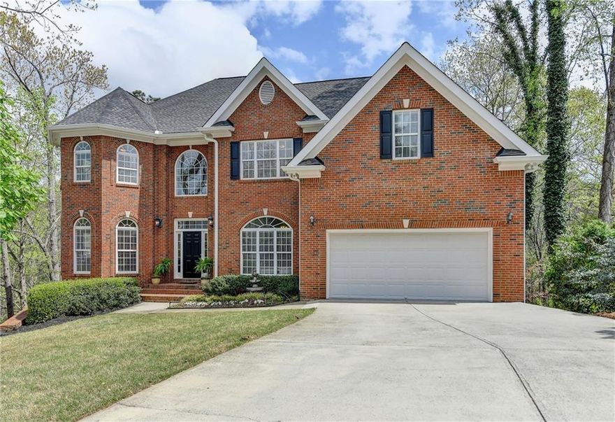 This charming traditional brick home is nestled in a cul-de-sac. As you step into the grand foyer with updated lighting, you're welcomed by a spacious dining room and a versatile bonus living area or main-floor office. The two-story family room features a new light fixture, abundant natural light, and access to a deck that overlooks a private, wooded backyard. This home features neutral paint throughout, a freshly painted exterior (2024), and a restained deck (2024). 

The kitchen, open to the family room, showcases stained cabinetry, granite countertops, an island, a pantry, and an eat-in area with deck access—perfect for outdoor entertaining. The main floor also includes a laundry room and a guest room with a full bath.

Upstairs, the expansive owner's retreat offers a fireplace and luxurious ensuite bathroom with a soaking tub, double vanities, a walk-in shower, and a large walk-in closet. Three additional bedrooms provide generous closet space; two share a Jack-and-Jill-style bathroom, while the third has a private ensuite bath.

The terrace level features a full kitchen, three additional bedrooms or flexible bonus spaces, a full bathroom, and a cozy fireside family room that opens to a deck area. It also includes a spacious bonus area, a game room, and abundant natural light. A private entrance provides direct access to the driveway.

This home also boasts a fourth-level sub-basement, currently unfinished, offering potential for additional living space or extra storage.

Conveniently located near shopping, dining, and Newtown Park, this home is part of the Nesbit Lakes community, which offers sidewalks, a pool, tennis courts, pickleball, a clubhouse, a playground, and a scenic lake for fishing or kayaking.
