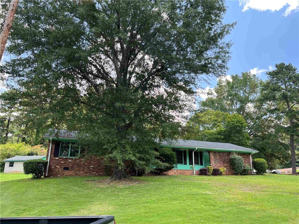 A sweet little gem located in the heart of East Point! Completely put your own spin on it or keep it in its original RETRO state. This three-bedroom home, with two full baths, is located on over a half acre. Your new property has a two-car carport, as well as a two-car private garage out back. A spacious, flat backyard is perfect for gardens and gatherings, as well as a huge front yard to plant your rose bushes and hydrangeas. Welcome Home!