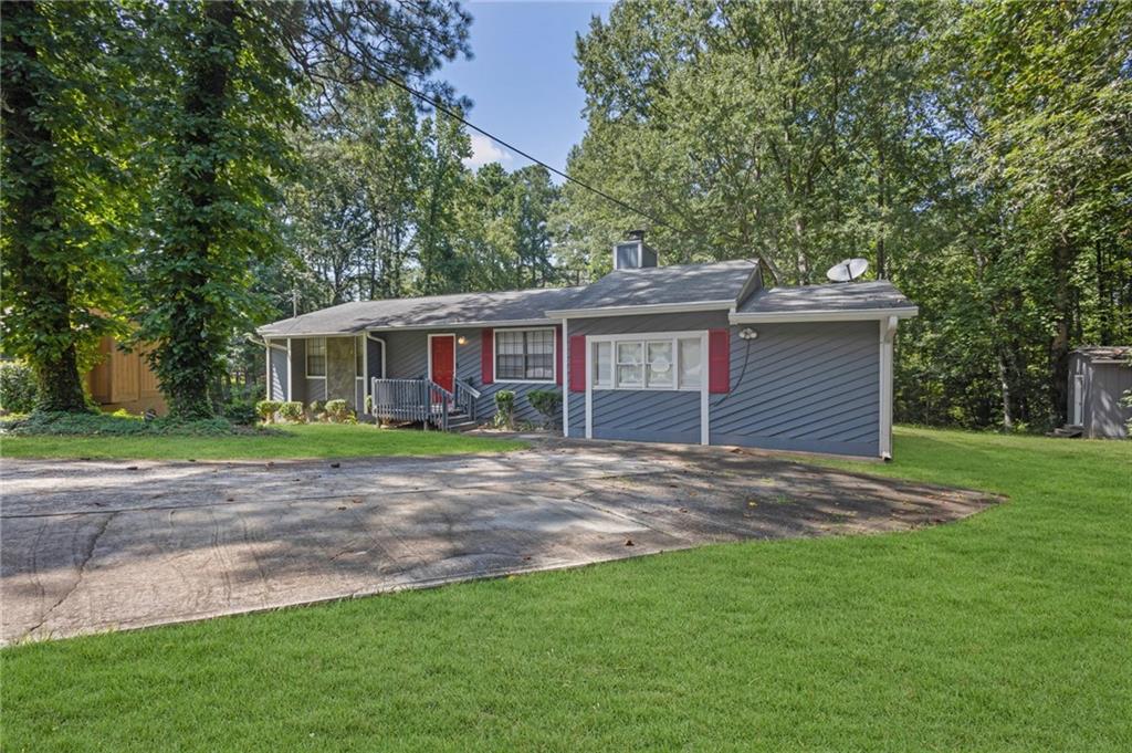 Great Opportunity in Riverdale! This home was completely renovated in 2013 and features a brand-new HVAC system.
The interior boasts a spacious, updated kitchen with stained wood cabinets, sleek black appliances, and a convenient island perfect for quick meals. You'll also find a separate dining room, ideal for family dinners, and a living area with a cozy wood burning fireplace. Outside, a private back patio leads to a large backyard, perfect for outdoor activities and relaxation, and there's a small shed for additional storage. This property is ideally located close to I-75, Clayton State University, and Hartsfield-Jackson International Airport, making it an excellent option for either a new homeowner or an investor.