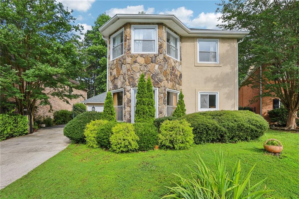 ***Tons of Natural Light***High Ceilings***Updated Modern Kitchen***Community Amenities***Elegant Gated Home in Prime Alpharetta Location! Welcome to this stunning home, perfectly situated behind a gated entry in one of Alpharetta’s most sought-after swim/tennis communities. Step inside to discover gorgeous hardwood floors that flow seamlessly throughout the entire main level. The spacious living room features soaring two-story ceilings, a cozy fireplace, and dazzling chandeliers that add a touch of luxury and warmth. The updated kitchen is a showstopper, featuring on-trend white cabinetry, granite countertops, a stylish tile backsplash, stainless steel appliances, and a large island with bar seating—ideal for casual meals or entertaining. A light-filled dining room with a charming bay window provides the perfect space for more formal gatherings. The main-level primary suite is a true retreat with vaulted ceilings, a fireplace, and dual outdoor access. The luxurious en-suite bath offers dual vanities with granite countertops, a separate soaking tub, and an oversized, fully tiled, frameless glass shower. A convenient laundry room and half bath complete the first floor. Upstairs, you'll find two spacious secondary bedrooms, both with access to an updated full hall bath featuring granite countertops and a fully tiled shower. Outside, enjoy a fully fenced yard shaded by mature trees for added privacy—perfect for relaxing or entertaining outdoors. Located in the heart of Alpharetta, this home offers unbeatable convenience with quick access to Avalon, North Point Mall, downtown Alpharetta Square, GA 400, and top-rated schools. Enjoy resort-style amenities including a saltwater pool and tennis courts—all in a vibrant, established community. Book your tour today!
