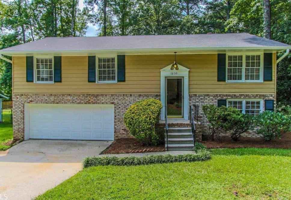 This updated brick-front home is move-in ready with a 2-car garage and fenced backyard. Recent upgrades include fresh paint inside and out, new hardwoods in the foyer and living room, new carpet, updated vanities, granite countertops, and modern light fixtures. The main level offers a large bonus room with a half bath, while the kitchen features a pantry, black appliances, backsplash, and easy access to the dining area and back deck. Outside, enjoy a lawn, fresh landscaping, and plenty of space to relax or entertain.