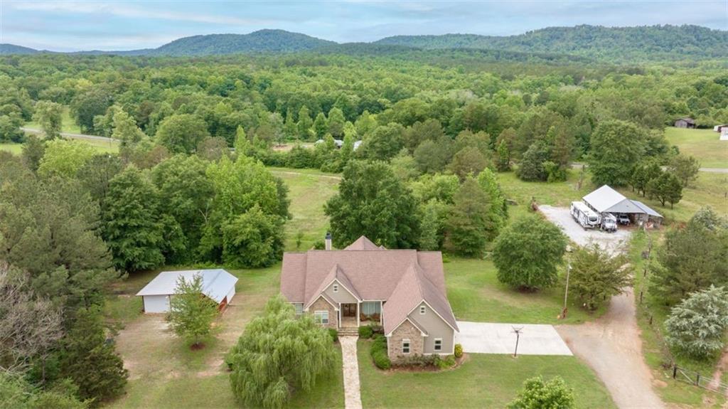 Stunning 5 bedroom home on 10+ acres with creek, two barns, and endless possibilities! Welcome to your dream retreat! Nestled on over 10 acres of picturesque countryside, this spacious 5 bedroom, 4 bathroom craftsman offers the perfect blend of comfort, functionality, and outdoor adventure. Step inside to soaring tall ceilings and an open, airy layout that immediately feels like home. The main level features 4 generously sized bedrooms and 3 full bathrooms, including a luxurious primary suite with a private ensuite and his and hers walk-in closets. The heart of the home is the expansive kitchen, complete with stainless steel appliances and ample space for cooking and entertaining. Downstairs, the partially finished terrace level is ideal for teens, guests, or an in-law suite. It includes a bedroom, full bathroom, cozy living space, laundry hookup, and tons of storage options. Whether you're looking to build multiple homes, create a family compound, or simply enjoy the wide-open space, the possibilities are endless. Outdoor enthusiasts will love the two barns-one pole barn with power and one with power and water- perfect for a workshop, animals, or hay storage. Don't miss this unique opportunity to own a versatile estate with room to grow, play, and live the life you've always imagined! Additional acreage across Hwy 184 with a creek available can be added to the sale for an additional cost.