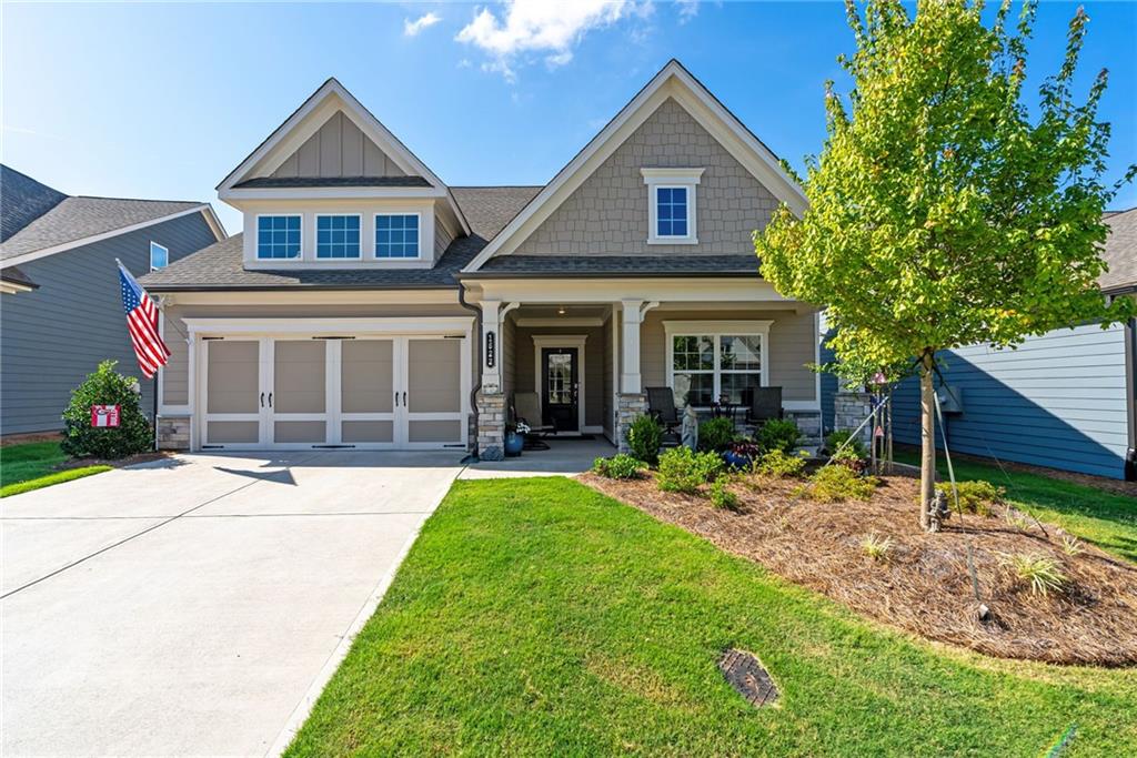 4 bedroom, 3 bathroom ranch-style home with a spacious upstairs loft has it all and is nestled in the sought-after, gated community of Hickory Bluffs off Riverstone Parkway. The main level features everything you need for day-to-day living, including: A chef’s kitchen featuring white shaker cabinets, stainless steel appliances, a 5-burner gas cooktop + griddle, built-in microwave/convection oven, wall oven, quartz countertops, and an oversized island with abundant cabinet and pantry space. The gorgeous kitchen is open to the living room adorned with built-in cabinets and shelving that perfectly frame the stately gas fireplace. Also on the main level is the spacious primary suite with ensuite bathroom boasting a zero-entry shower, upgraded glass door, and dual vanities. A versatile study/library makes an ideal office, reading nook, or hobby space. Laundry room, mudroom, and an additional bedroom and full bathroom round out just some of the best mainfloor features of this floorpan! Upstairs leads to the perfect extra hangout space + a guest room and full bathroom. Perfect for hosting friends and family! You'll love the breezy mornings and quiet evenings out on screened-in back porch. The backyard is fenced for tiny humans or four-legged fur babies, either way, it's an added bonus to this beautiful home! Located in a vibrant 55+ community, residents enjoy a resort-style lifestyle with a stunning clubhouse, pool, tennis and pickleball courts, and a full calendar of social activities. HOA includes all lawn maintenance, so you can truly relax and enjoy the good life. This is low-maintenance, luxury living at its best— come see for yourself!