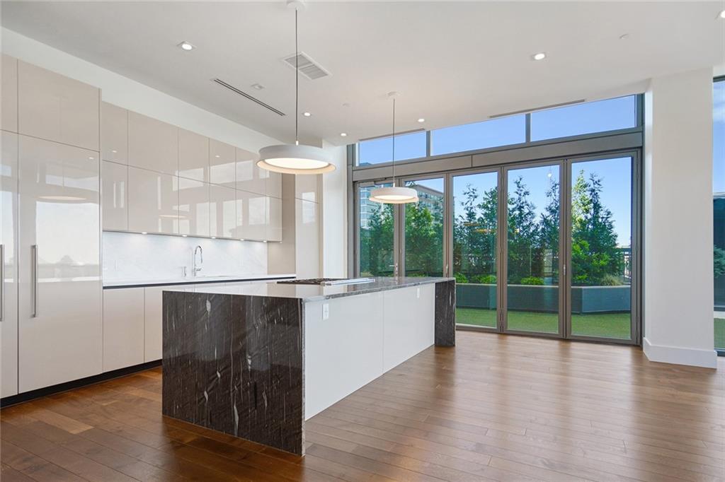 Gorgeous unit in The Charles is a one of a kind condo that combines two units to create a spacious four bedroom floorpan. Located on the amenity level has unit offers private terrace or garden patio for all 4 bedrooms. The Nanawall folding door system creates a seamless transition from indoor to outdoor, ideal for entertaining. Sleek and sophisticated kitchen with waterfall marble counter island and all Gaggenau appliances. 1,000 bottle gallery wine wall with state of the art climate control, a full wet bar with ice maker, refrigerator & dishwasher. Living room has gas fireplace and floor to ceiling windows. Private study has built-in bookcases and French iron doors. Oversized master with sitting area, dual walk-in custom closets. Luxurious spa-like master bath with double vanities, separate shower and Victoria Albert soaking tub. Four car private enclosed garage with storage unit and private access to the elevator. The Charles offers exceptional amenities including saltwater pool, fitness center, stunning club room, fire pits and dog walk. The Charles also has doorman/valet, security guard and concierge.
