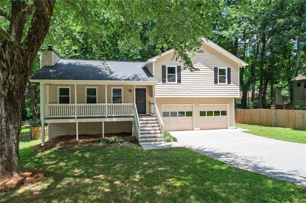 Affordable. Convenient. Move-In Ready. This one checks all the boxes—NEW ROOF, NEW WINDOWS, NEW GRANITE COUNTERTOPS, NEW KITCHEN SINK, AND FRESHLY PAINTED INSIDE AND OUT. Located in a prime spot with easy access to shopping, restaurants, major expressways, all of this in the sought-after Kennesaw Mountain High School district—it’s the total package. Inside, you’ll find a smart and functional floor plan with three bedrooms and two full bathrooms. The cozy Great Room features a welcoming fireplace perfect for quiet nights or lively gatherings, and there’s a separate dining room for family meals or game nights. The freshly painted interior gives the home a bright, clean, move-right-in feel. Step out front to a shady rocking-chair porch—perfect for morning coffee or afternoon chats. Out back, the deck is ready to place your grill for those weekend cookouts. An oversized two-car garage offers great storage and includes a convenient side-entry door to the yard. All that’s missing is you. Come see it today—and start living your best life.