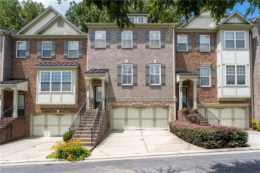 Welcome to 2090 Cobblestone Way Where Practical Living Meets Unexpected Charm! Tucked within a highly desired gated community, this three-story townhome is over 2,500 square feet and offers a surprisingly spacious layout that balances comfort with everyday function. Featuring three well-proportioned bedrooms each with its own en-suite bath. The expansive main level invites you in with warm hardwood floors, a cozy gas fireplace, and a kitchen that, while tastefully finished with granite counters and stainless steel appliances, offers even greater potential when experienced in person. The layout flows naturally to a private deck, a serene space for quiet mornings or casual evening gatherings. Upstairs, the oversized primary suite provides a quiet escape, complete with an extra versatile sitting area, tray ceiling, and a generously sized bathroom designed for comfort. Two additional bedrooms, the dining room, and the patio leave space for everyone! While exterior upkeep is handled for you, the real value lies in the quiet pride of ownership throughout the community. With easy access to I-85, GA-400, I-285, Buford Hwy and Peachtree, you are always connected. Minutes from Buckhead and walking distance to the local charm of Brookhaven, you are guaranteed to enjoy daily living in Cobblestone at Brookhaven!