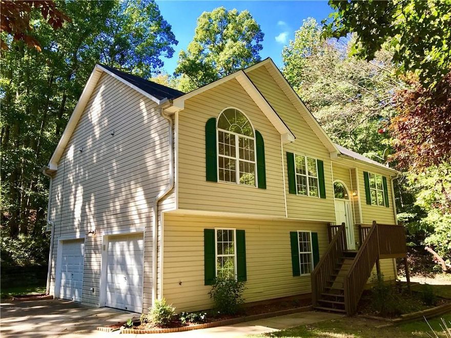 Located in the desirable Eagles Crest neighborhood just off I-675, this stunning home offers a private setting and is truly move-in ready.  Inside, you'll love the spacious 4-bedroom, 2-bath layout, perfect for families or anyone needing extra space. The kitchen is a chef's dream with granite countertops, stainless steel appliances, and ample cabinet space. The main living areas feature beautiful hardwood floors, while bedrooms are finished with plush carpet for comfort. A gorgeous fireplace with ornate woodwork and built-in mirror serves as the focal point of the living room.  The lower level includes a massive guest suite or media room with a cathedral ceiling and ceramic tile flooring, plus an additional unfinished room ideal for an office, gym, or storage. Throughout the home, vaulted and cathedral ceilings create an open and airy feel you'll love.  Don't miss this opportunity to own a home that combines elegance, space, and privacy in a fantastic location!