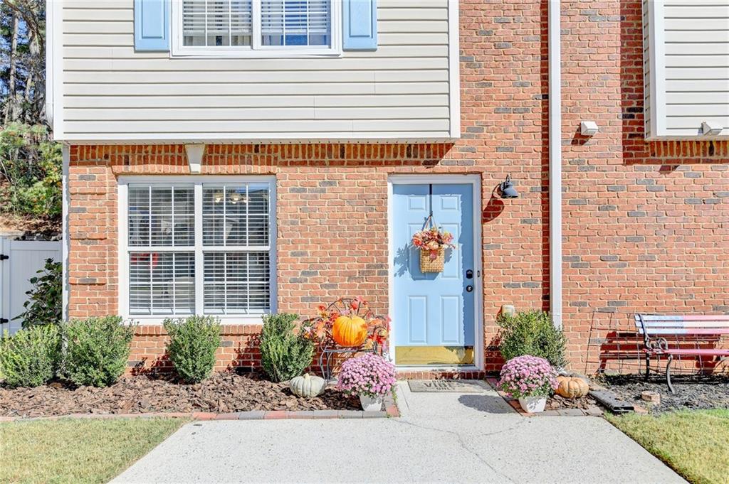 Entrance to property featuring brick siding