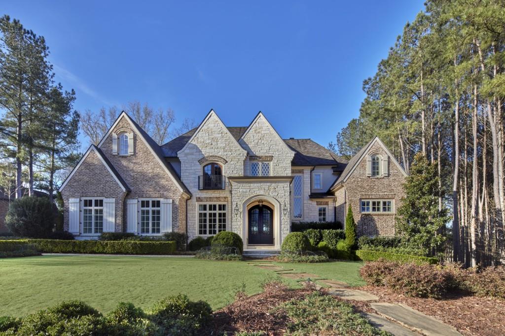 Magnificient Limestone and Brick estate home located in The River Club. This home site is stunning with view of the golf and lake offering total privacy with only the Chattahoochee River beyond that. Backyard is enhanced by beautiful English Garden style landscaping. From the entrance, the Foyer is welcoming and open to the formal Dining Room and the details become apparent in the custom metal handrails along the stairs to the 2nd floor. Large fireside Great Room open to beautiful well equipped kitchen and breakfast room. Luxurious owners suite on main with Herringbone pattern in hardwood floors as you enter will note you have entered somewhere special. The suite features bath with separate soaking tub, oversized shower with zero entry dual vanities, ladies make up vanity and large His and Her closets. A light filled sitting room completes the suite.. Upstairs you will find 3 secondary bedrooms. Two of the bedrooms are mirror images in size and features of the Owner's Suite complete with spa baths and sitting rooms and massive closet space. Both of these suites also enjoy a private roof top terrace with views to the lake/golf, Convenient elevator service to all three floors. In addition to the 3 bedrooms, the 2nd floor has a privare family room/kid's den Lower level is open for entertaining and boasts a custom bar, media room, state of art home theater, masseuse room and guest suite with bath equipped with sauna. This home has many very unique finishes that can not be duplicated like reclaimed beams, ceiling treatments, door hardware, theater room doors, lighting fixtures and so much more than can listed here. If you are looking for finer details and finish, look no further!