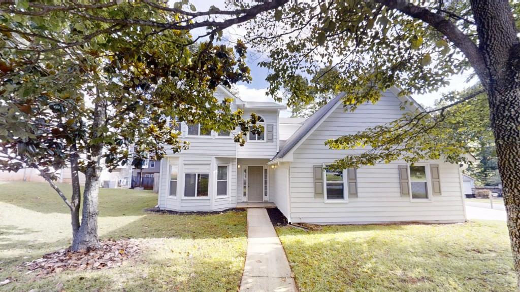 Welcome to this beautifully updated 3-bedroom, 2.5-bath home in the sought-after Hamby Place community! Featuring fresh paint throughout and durable LVP flooring on the main level and in bathrooms, this home offers both style and functionality. Upstairs, you'll find plush carpeting in all bedrooms for added comfort. The cozy family room includes a charming fireplace, perfect for relaxing evenings. The kitchen is a standout with crisp white cabinets, sleek stone countertops, and stainless steel appliances ideal for both everyday living and entertaining. Enjoy a spacious primary suite with a large bath, plus a private rear patio and fully fenced backyard that's perfect for gatherings, pets, or play. Located just minutes from the Peach Pass on/off ramp of I-75, this home offers unbeatable access to commuting, shopping, dining, and more. Don't miss your chance to call this move-in-ready gem home!