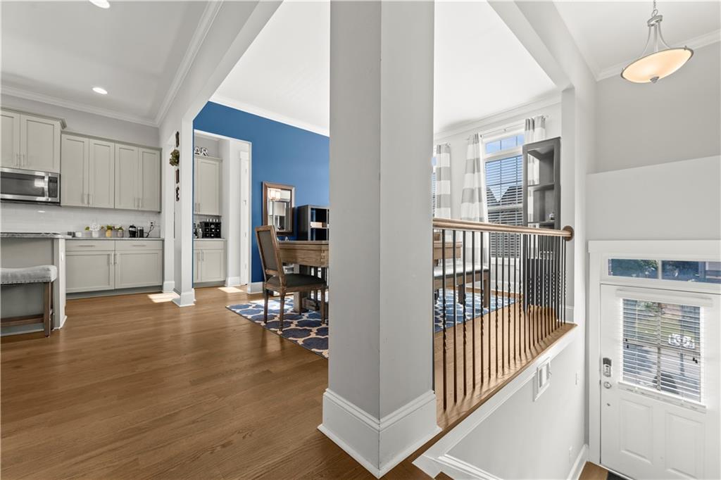 Priced under appraised value!This turnkey townhome offering an exceptional blend of elegance and functionality, perfectly situated in a vibrant community. This exquisite three-bedroom, three-and-a-half-bathroom home is designed with meticulous attention to detail and boasts an array of features that cater to modern living. Step inside to find a welcoming foyer that opens up to the open-concept main floor, where 10-foot ceilings and gleaming hardwood floors create a spacious and inviting atmosphere. The family room has a cozy stone fireplace, providing the perfect space for relaxation and entertainment. A gourmet kitchen awaits culinary enthusiasts, featuring granite countertops, a gas range, a large kitchen island, and a walk-in pantry, all designed to elevate your cooking experience. The upper level offers plush carpeted floors leading to the generously sized bedrooms. The oversized primary suite is a true haven, complete with custom walk-in closet and a luxurious ensuite bathroom featuring a double vanity with his & hers sinks. Additional bedrooms are ideal for family or guests, each providing ample space and comfort. Venture to the fully finished basement, which transforms into an apartment-style retreat. This versatile area of the home can serve as a home office, media room, home gym, or in-law suite. With its own entrance, this space could easily accommodate guests or serve as a private workspace. The main floor deck, perfect for dining or enjoying a peaceful morning coffee with close view of the neighborhood pool. The property also includes a two-car garage for added convenience. Community amenities elevate the lifestyle further with access to a pool, clubhouse, tennis courts, a dog park, and a playground for your enjoyment. Plus, the location is unbeatable—just minutes from I-285, you'll have quick access to The Battery, The Beltline, downtown and midtown Atlanta and an array of shopping and dining options at Westside Village and beyond. This elegant townhome embodies both comfort and style, offering an idyllic setting for modern family life or hosting guests for entertainment purposes. Imagine the possibilities of calling this place home. Don’t miss the chance to experience this magnificent home firsthand. Contact us today to schedule your private viewing and discover all the amazing features this property has to offer. Welcome to your new home!