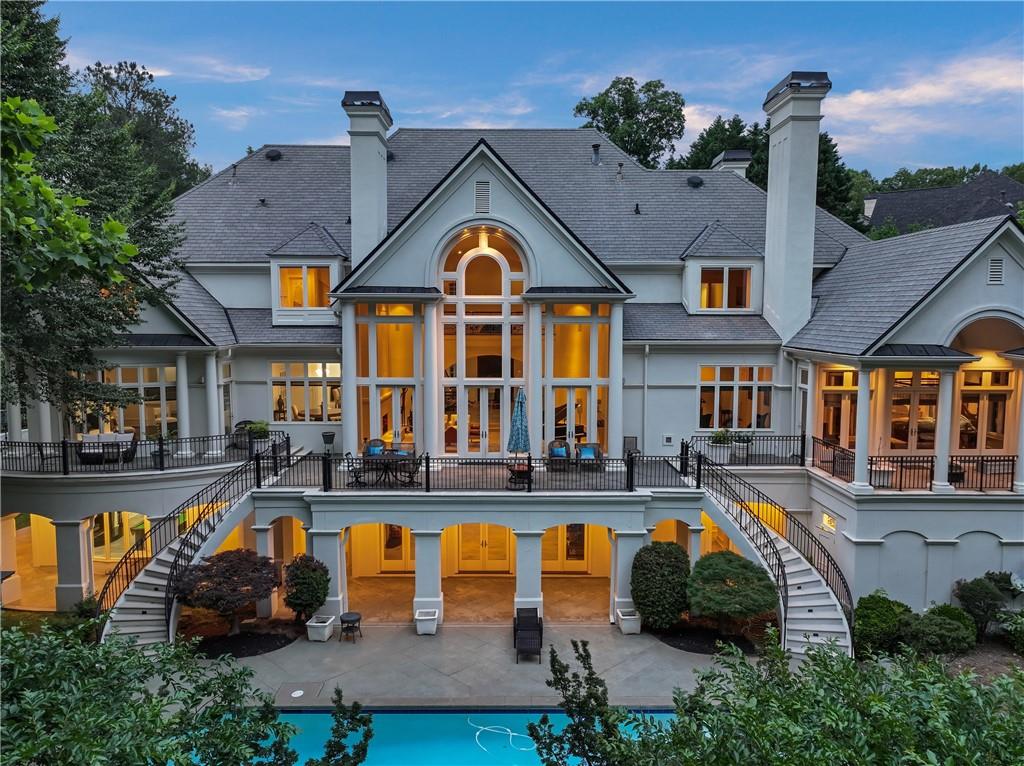 Welcome to your dream home nestled in a tranquil cul-de-sac, set within the exclusive and coveted Country Club of The South gated
community, with unparallel views of the Chattahoochee River that flows down from the mountains of north Georgia. This European white
stucco masterpiece rests on over one private acre with lots of privacy. From the moment you approach the home, you will feel the sense of
luxury and grandeur with an inviting and oversize driveway, that features majestic columns and 35-foot p rte-cochere entry and 4 car
garage. This remarkable estate boasts stunning landscaping and hardscaping, creating a picturesque setting that blends seamlessly with
the breathtaking natural surroundings. The welcoming 8-foot double stained wood doors, lead to a grand foyer with soaring 22-foot barrel
ceiling and twin elegant wrought iron curved staircases. Custom benches and travertine floors lead to the magnificent formal living room
with soaring fireplace and windows, overlooking the secluded and stunning backyard with tranquil views of the river for ultimate living.
With a primary suite on main, office and elevator to all floors, this home brings modern convenience with an opportunity to enjoy all the
amenities it has to offer. Banquet size, dining room with butler's pantry. Informal breakfast room adjacent to the glass curved windows in
the family room both, with views of the backyard and featuring one of 7 fireplaces. Sophisticated easy living modern kitchen with high end
appliances that includes double Sub-Zero fridge and freezer, wolf cooktop, double ovens, warming drawer, walk in pantry and very
extensive quartz countertops island. The luxurious Primary Suite, offers windows on two sides to enjoy the views of the Chattahoochee
river, fireplace, sitting room and a private veranda with tranquil views. The bathroom features a whirlpool soaking tub, dual sinks, a make-
up vanity, two private water closets. Two walk-in closets with floor to ceiling extensive cabinetry and secret access to the library office. In
the sitting room, a private spiral staircase next to the elevator, allows access to the exercise room and terrace level. Second Primary Suite
also conveniently located upstairs featuring 3 more bedrooms in addition to a private en-suite bedroom with fireplace. Terrace level offers
the ultimate entertaining space for fitness and relaxation. Sauna, steam room, exercise room and extra space for a potential golf simulator,
media room, and a complete en-suite bedroom. Large area with pool table, bar area, fireplace and easy access to the lush backyard. The
pool area with covered outdoor kitchen, jacuzzi and large pool overlooking the river is the ultimate entertaining space. This extraordinary
home located in John's Creek have excellent public and private institutions. The lifestyle in this exclusive, gated community includes The
Jack Nicklaus-designed 18-hole golf course, brand-new $3 million clubhouse and pool, complete with an Olympic-size pool, kids' slides, and
water park. Tennis and pickleball courts, social events, and an elite country club lifestyle. With proximity to downtown Alpharetta and
Avalon for shopping, restaurants and entertaining along with access to parks and recreation nearby. You can have it all in Johns Creek.