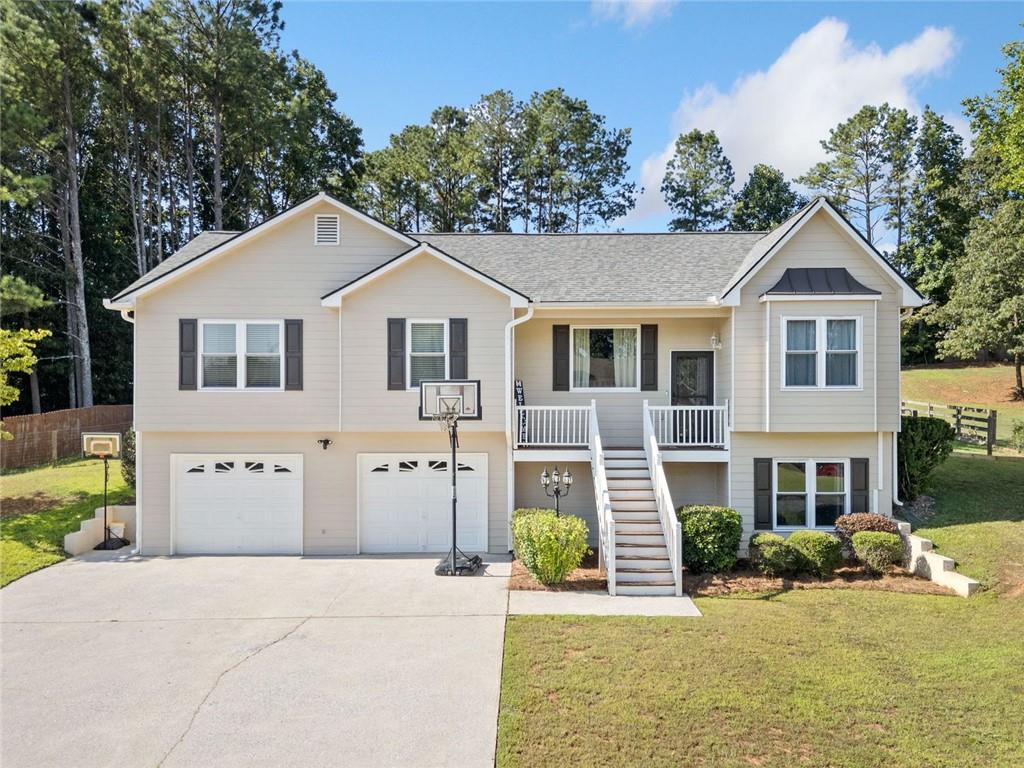 Welcome to this charming 4-bedroom, 3-bathroom raised ranch in Acworth in the Hickory Lake community that has No HOA! This home features hardwood and tile throughout the main level. The open floor plan features a spacious living area with vaulted ceilings with a cozy fireplace. The separate dining room offers an ideal space for entertaining, while the eat-in kitchen boasts granite countertops and stainless steel appliances. The primary suite features a trey ceiling, a spacious walk-in closet, and a private bath with a double vanity, a soaking tub, and a separate shower. Two additional bedrooms share a full bath, offering comfort and convenience for family or guests. The fully finished basement offers an in-law suite complete with a great room, full kitchen, bedroom and bathroom. Enjoy the outdoors in your private, fenced backyard on your deck or in your above ground pool just installed in 2024. Located just minutes from shopping, dining, and excellent schools, this home offers the perfect blend of comfort and convenience. *PROFESSIONAL PHOTOS COMING SOON*