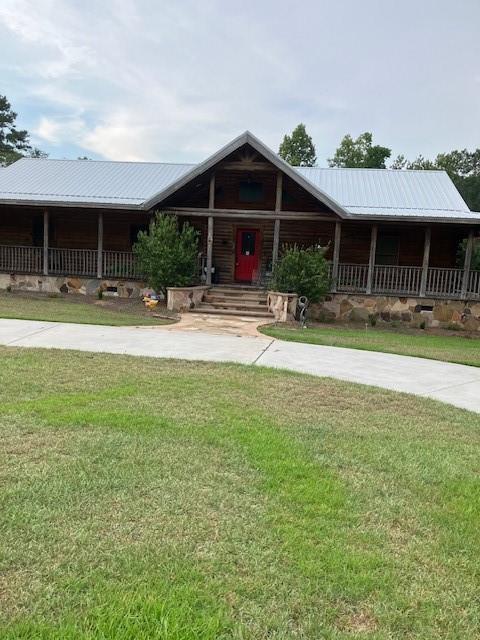 Nestled on 5.67 acres of tranquil land, this custom-built log cabin at 1293 Pine Ridge Dr in Claxton, GA, offers a perfect blend of rustic charm and modern comfort. Built in 2012, the home features 2,036 sq ft of thoughtfully designed living space, including 2 bedrooms and 2 bathrooms. The open-concept layout is highlighted by a spacious family room with vaulted ceilings and a stone fireplace, creating a warm and inviting atmosphere. The kitchen boasts custom cabinetry, granite countertops, and stainless steel appliances, ideal for both everyday living and entertaining. Additional spaces include a sunroom, laundry room, and a den, providing ample room for relaxation and hobbies.