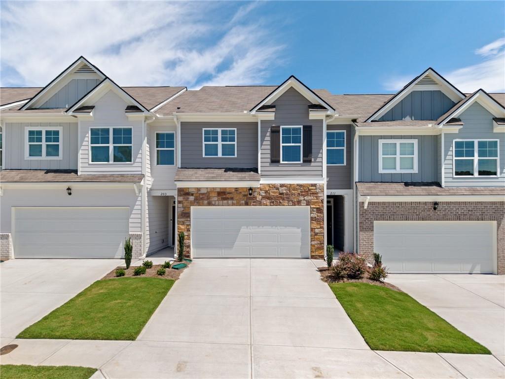 Welcome to 211 Stoneybrook Drive, a newly completed townhome in the Mountain Park community of Dahlonega. This spacious two-story home offers 3 bedrooms, 2.5 bathrooms, and nearly 1,900 square feet of modern living with a two-car garage. The open-concept main level features a welcoming foyer, a large family room with an electric fireplace, and a stylish kitchen with granite countertops, subway tile backsplash, white shaker cabinetry, stainless-steel appliances, and a center island. A dining area with access to the back patio and a convenient half bath complete the first floor. Upstairs, the primary suite includes a walk-in closet, dual vanities, soaking tub, and separate shower. Two additional bedrooms, a loft, a full bath with double vanity, and the laundry room with washer and dryer included complete the upper level. All appliances are provided, including refrigerator, range, microwave, dishwasher, and washer/dryer. Mountain Park residents enjoy sidewalks throughout the neighborhood along with a pool and clubhouse featuring a fitness center. Conveniently located near the University of North Georgia, downtown Dahlonega, GA-400, shopping, dining, and North Georgia wineries, this home blends comfort and convenience in an ideal location.