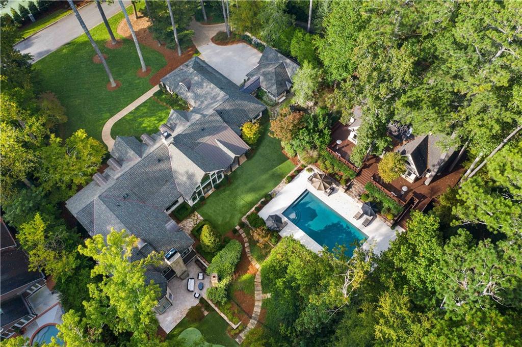 Breathtaking retreat (SEE STUNNING VIDEO) on coveted North Island in Sandy Springs, a few minutes from Chastain Park, is sited beautifully on a 3.4 AC private setting! 2013 to the studs, perfection renovation by Canonbury Homes offers exceptional luxury lifestyle w fabulous outdoor amenities PLUS a single family sized, Sea Side feel, 2br/2ba guest house! Main house enjoys elegantly casual, one level living, thoughtfully designed for family & entertaining flow. Bathed in light & stunning views, simply invites the outside in. Common areas are gorgeous, airy, each with fabulous detail. Sophisticated white kitchen & breakfast room. Lovely fireside master suite opens to walkout pool/grounds & putting green. Spa master bath has soaring ceilings & coffee station. 3 additional bedrooms complete main level. Terrace level includes in-law/nanny suite, billiards, wine cellar, pub, gym & more. Grounds are lush with playyard, walk-out salt water pool, pergola, newly resurfaced tennis court, waterfall with Koi, cutest chicken coup, outdoor fireplace, firepit, mosquito system & generator. All here in this rare gem of a property. Ideal location, just outside City of Atlanta, having lower taxes!
