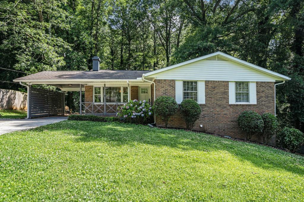 Up to $12,500 Toward Closing Costs or Rate Buy-Down! Step into this Fully Renovated Four-Bedroom, Two-Bathroom Ranch where classic charm meets modern style on a spacious Half-Acre Lot just minutes from the Silver Comet Trail, The Battery, and Smyrna Market Village. Inside, every detail shines with Fresh Paint, Refinished Hardwood Floors, and Designer Updates throughout. The bright, open layout begins in a welcoming Living Room with a Cozy Fireplace that flows seamlessly into a Sunlit Dining Room. A true centerpiece, the All-New Kitchen features Custom Cabinets, Quartz Countertops, Stainless Steel Appliances, and a Cheerful Breakfast Nook with access to the Rear Deck overlooking a tranquil, wooded Backyard. The Primary Suite offers an Updated Ensuite Bath, while two additional Bedrooms share a Beautifully Renovated Hall Bath. Downstairs, the Partially Finished Basement expands your options with a Fourth Bedroom/Home Office/Gym, a Workshop with Built-In Workbench, and plenty of space for storage or future growth. Pull into the Attached Carport and enjoy charming backyard views the moment you arrive. Outside, entertain or unwind on the Rear Deck or Lower Stone Patio, both nestled in a Private, Wooded Setting. This is a Turnkey Opportunity in a coveted location don't miss it!