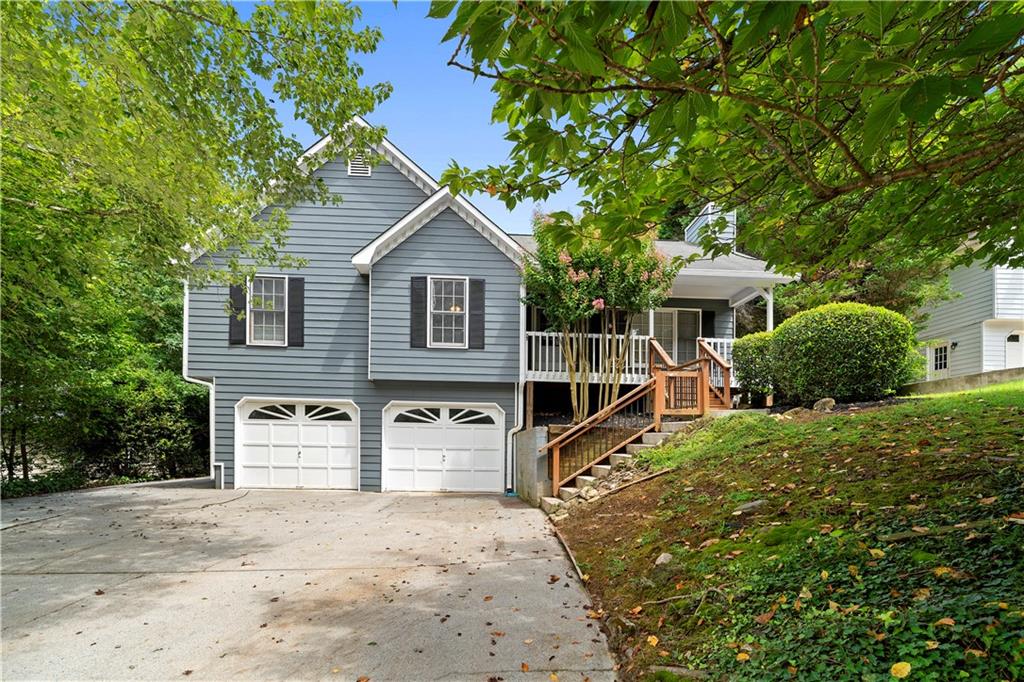 Fantastic home with pool in Woodstock, GA. Hurry and see this home featuring a new roof, three bedrooms and two baths on the main floor, plus an extra bedroom on the lower level. The generously sized living area is beautiful with a stone fireplace, perfect for cozy nights around the TV, and elegant tray ceilings. The breakfast and dining areas are bright with a white motif and overlook the backyard and pool. The large master suite includes an en suite bathroom with double vanity, standalone shower, and soaking tub. The partially finished lower level offers living space, storage, and a two-car garage. The backyard is a highlight with a large deck, fenced yard, and stunning pool. Don’t miss your chance to enjoy it while the weather is warm.