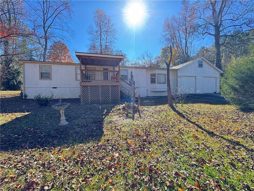 Charming ranch home on a spacious .65-acre lot in Acworth! Relax on the inviting front porch or enjoy the open layout inside. The 2-car garage with a loft offers plenty of storage or hobby space. This home is full of potential and ready for you to make it your own—a perfect opportunity to add your personal touch and bring out its full charm. Conveniently located just minutes from Lake Allatoona, where you can spend weekends boating, fishing, hiking, or enjoying the water. Enjoy the perfect blend of peaceful suburban living and outdoor adventure right at your doorstep!