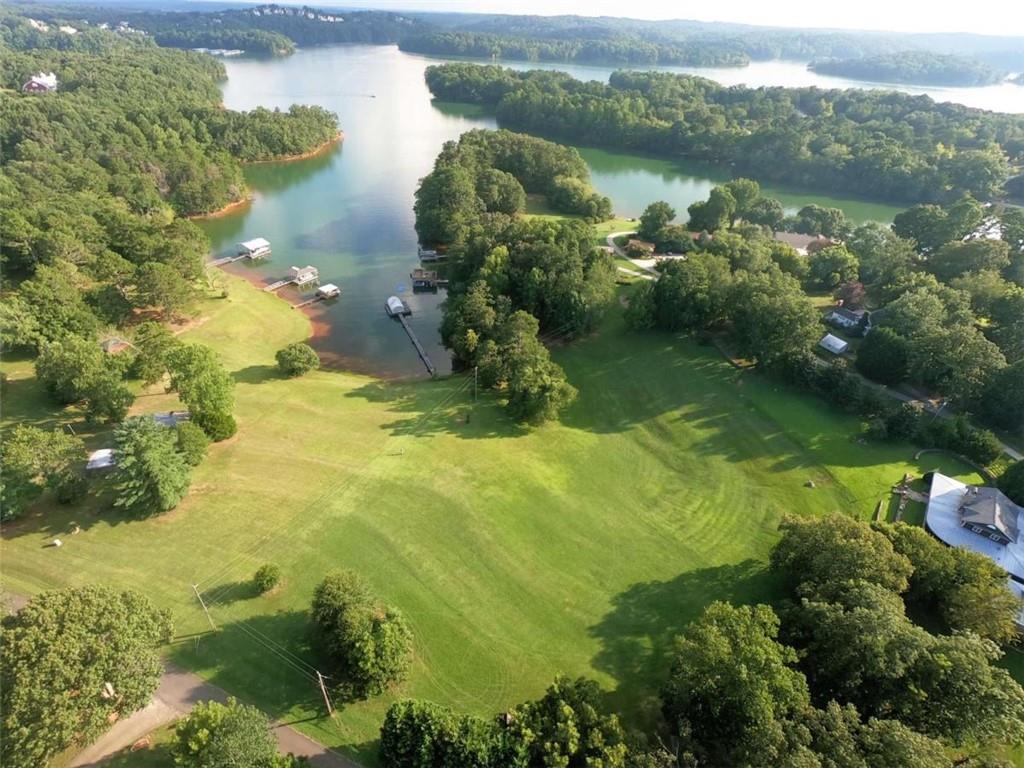 Tremendous opportunity to have that picture perfect and rarest of lakefront homesites that offers Gentle Grass to Water with grandfathered mowing permit, Breathtaking Views, private twin slip dock with full party deck and boat lift, and the most pictureque setting you could ever hope for on Lake Lanier! Soil testing has been completed and ready for a lakefront design of your dreams!