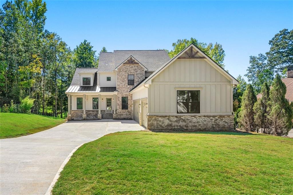 Welcome to this exceptional home in Traditions of Braselton, offering over 3,500 square feet of finished living space plus a 2,134 square foot unfinished basement with endless potential for customization. The floor plan is thoughtfully designed with two primary suites— one on the main level, featuring LVP flooring and a spa-inspired bath, and another upstairs—making it the perfect long-term home for families, multi-generational living, or empty nesters seeking comfort and flexibility.
As you enter, you are welcomed by soaring ceilings and a double-height living area that fills the home with natural light and creates an inviting sense of openness. A versatile flex space on the main level offers the perfect setting for a private office, study, or playroom. The kitchen is a true centerpiece, featuring ceiling-height cabinetry, modern finishes, a built-in wine rack with chiller, and a wet bar/coffee bar that enhances both everyday living and entertaining.
Attention to detail is evident throughout with custom wall treatments, stylish fixtures, and beautiful wood accents that provide warmth and character. The interior fireplace adds charm and comfort, while the outdoor fireplace anchors the generous exterior living space, perfect for gatherings or quiet evenings. Upstairs, secondary bedrooms are complemented by a spa-inspired bath experience, with both primary suites featuring shower and tub combinations designed for relaxation.
The home is completed with a three-car garage featuring soaring ceilings, offering ample storage and utility space. The unfinished basement provides incredible potential for future customization—whether you envision additional bedrooms, a game room, a theater, or a home gym, the options are limitless.
This residence combines elegance, functionality, and modern style, making it one of the most desirable floor plans in Traditions of Braselton. Schedule your showing today and discover a home that is truly move-in ready with room to grow.