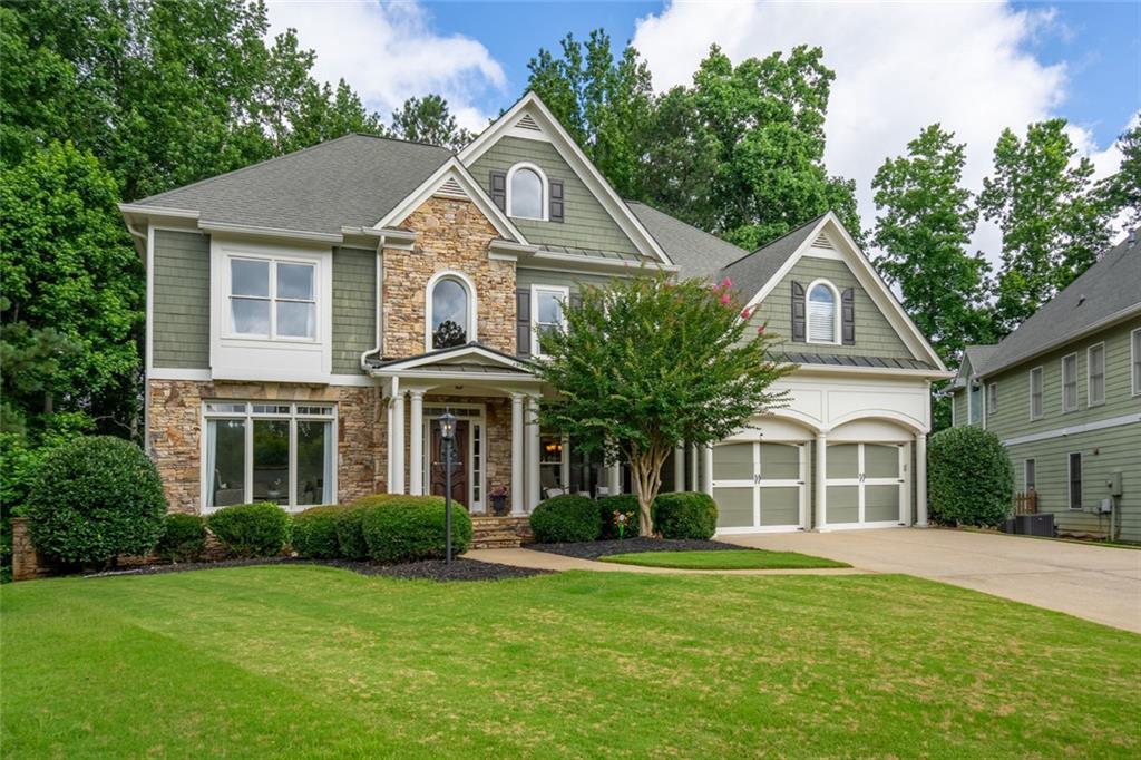 Across from a picturesque community central park and tucked into one of Marietta’s most loved swim/tennis communities, this five-bedroom, four-bath home combines smart design with relaxed, everyday style and show-stopping curb appeal. The main level delivers a layout that lives and flows perfectly: a bedroom/guest suite, cozy living room, separate dining room, and a two-story great room filled with natural light. The kitchen is equal parts function and warmth, with granite counters, rich wood cabinetry, loads of storage, breakfast area, a large pantry and separate laundry convenient to the garage for busy households. Upstairs, the oversized primary suite feels like its own corner of calm. French doors open to a private balcony with tree-lined backyard views. The spacious bath features dual vanities, a soaking tub, separate shower, and a fully customized walk-in closet. One upstairs bedroom has its own en-suite, while two more share a Jack-and-Jill bath—great for kids, guests, or a little more space to spread out. The walk-out basement is full of possibility. Already framed out with multiple rooms, and plumbed it’s a blank canvas ready for your gym, theater, play room or anything in between. And the backyard? Level, fenced, and ringed with mature trees—Whether you’ve got kids, dogs, a green thumb, or a hammock habit—this space delivers. Minutes to Marietta Square, with fast I-75 access for easy commutes to Atlanta or the airport, this home checks all the boxes—without blending into the crowd. Don’t wait to come see this home with a 10+ layout and location!