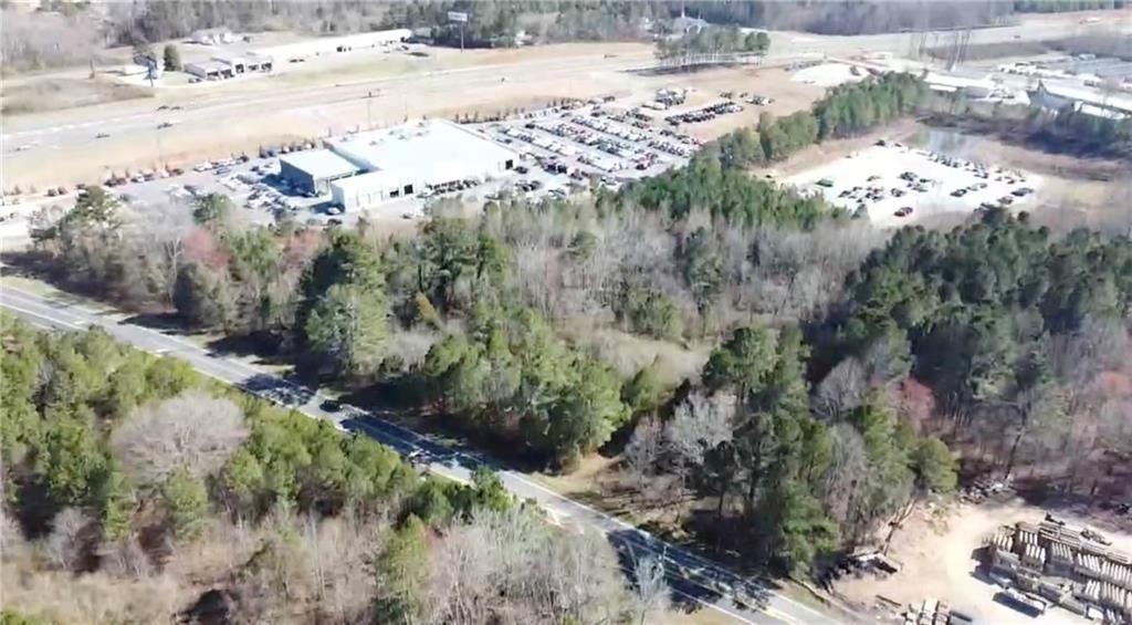 Great location! 7.38 acre property already zoned CBD - Commercial Business District with over 750 ft of frontage on Hubbard Town Road and within view of the intersection of Ga Hwy 400 (US 19) & Hubbard Town Rd. Intersection has traffic light and turn lanes with over 37,300 avg daily traffic count on Ga Hwy 400 according to GADOT. Property adjoins site of Don Jackson's auto dealership and CAT. Sanitary sewer located on site. Forsyth County water main located on north side of Hubbard Town Rd.