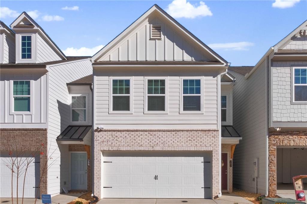 Nearly new single family detached home in conveniently located Pebblewood Grove! The floor plan features an open concept for everyday living or entertaining. The spacious kitchen features gray cabinets with granite countertops, tile backsplash & stainless-steel appliances. The HUGE island opens to an ample family room and dining area. Luxury Vinyl Plank floors extend throughout the entire main level. A backyard patio is available for relaxing or outdoor grilling. Upstairs features an oversized owner's suite with trey ceiling and walk in closet. The primary bath has an oversized shower with dual, raised height vanities and cultured marble top. Two secondary bedrooms share a tasteful hall bath. The laundry room is conveniently located on the second floor with a newer washer and dryer. The attached 2 car garage with carriage door and stone trim is complete with a 240V electric car charger outlet. The HOA takes care of routine lawn maintenance, exterior home maintenance and trash service. This a Canton address within the city limits of growing, vibrant Holly Springs. Minutes to Downtown Woodstock, Shopping, Home Depot, fitness, dining & I 575. Don't miss this opportunity to live in a brand-new home in a great location!! Application link - https://apply.link/kinuZyw Owner/Agent