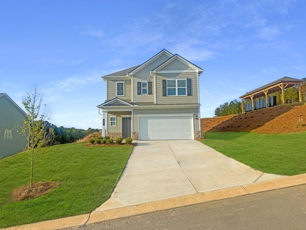 Move in Ready! The Braselton II plan in the Varnell Preserve community by Smith Douglas Homes. Located less than 30 miles from Chattanooga and only 20 minutes from the Chattanooga Airport! Discover the Braselton, a thoughtfully designed home that features a corner rear covered patio, easily accessed from the spacious eat-in kitchen with a central island, granite counters, tile backsplash, upgraded cabinetry and upgraded appliances. The kitchen flows seamlessly into a bright and open family room with a stylish linear fireplace. Vinyl flooring throughout the main level provide seamless transition from room to room. The open iron rail staircase leads to the second story where you will find the primary suite bath with a walk-in closet and separate shower, garden tub and dual vanity. A loft, two additional bedrooms, a shared hall bath and a convenient laundry room complete this level. Both stories feature Smith Douglas Homes signature 9ft ceiling heights. Seller incentives with use of preferred lender. Primary photo of home, secondary photos representative of plan not of actual home.