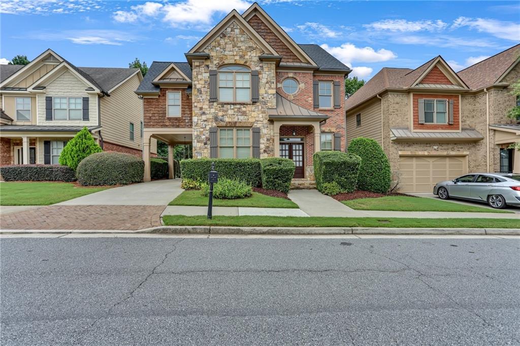 Discover exceptional, maintenance-free living in this stunning home, nestled within a secure gated community, offering privacy, style, and convenience at every turn. Located in the highly sought-after Peachtree Ridge school cluster, this residence boasts a fully finished basement complete with a second kitchen—ideal for multi-generational living, entertaining, or creating the ultimate guest retreat. Enjoy the ease of a covered carport with direct access to the main kitchen, making unloading groceries or hosting gatherings effortless. Inside, you'll find a sleek and modern kitchen outfitted with stainless steel appliances, perfect for the home chef. The master suite is a true showstopper, featuring a one-of-a-kind bathroom design that blends elegance and personality for a spa-like experience. Whether you're relaxing indoors or enjoying the peace of a gated neighborhood, this home offers the perfect blend of functionality and flair. Don’t miss your chance to own this uniquely versatile property. Schedule a showing today!!!