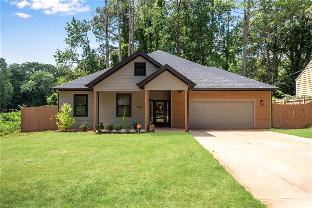 Furnished rental located next door to 5 acres of unbuildable nature reserve space! Hard to find newer construction in East Point! True one level ranch living and ALL ELECTRIC for lower utility bills. Hardwood foyer w/high soaring ceilings extending through-out home. Great room w/linear fireplace and double sets of French doors to the covered patio overlooking the private fenced backyard. High end island kitchen w/furniture venthood, French door fridge and walk-in pantry. Actual walk-in laundry room w/cabinets. Hardwood primary suite w/tray ceiling, desk and sitting areas. Primary bath features a double tile shower, double vanity and spacious walk-in closet. Three secondary bedrooms ALL feature ceiling fans and share a tile half bath w/double vanity. Located near Atlanta’s major highways, Hartsfield Jackson International Airport, the Porsche center, and Tyler Perry Studios. Lawn maintenance and trash service included in lease.