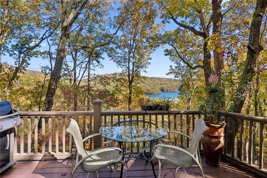 Experience tranquility and breathtaking views at this beautifully renovated one-bedroom, one-bath chalet overlooking Lake Petit and the North Georgia Mountains. Wake up each morning to the sunrise reflecting off the lake and enjoy peaceful evenings surrounded by nature. Inside, you’ll find a completely updated and tastefully furnished chalet—everything is brand new and designed for comfort. The bedroom features a king-size bed, and the living room includes a queen sleeper sofa for visiting guests. The modern bathroom offers a walk-in shower, and the fully equipped kitchen has everything you need—just bring your favorite food and wine. Relax in the cozy living room with a 54-inch Smart TV for streaming your favorite shows, or unwind in the bedroom with a 32-inch TV. Step out onto the spacious deck with ample seating and soak in panoramic views of Lake Petit and the surrounding mountains—perfect for morning coffee or evening wine. There is also a spacious laundry room in the lower level and the home is being sold fully furnished so all you need is your toothbrush! Located within the gates of Big Canoe, a premier mountain resort community just one hour north of Atlanta, you’ll have access to over 8,000 acres of pristine woodlands, meadows, lakes, and streams. Big Canoe offers world-class amenities, including a newly renovated Clubhouse with in and outdoor dining, championship golf courses, indoor and outdoor tennis courts, a fitness center with indoor pool, marina with pontoon, kayak, and paddleboard rentals, a trout-stocked fishing lake, over 20 miles of scenic hiking trails and wildlife abounds in this conservation community—you may spot deer, wild turkey, and other native animals right outside your door. This cozy mountain escape is perfect for a weekend getaway, full time residence or investment opportunity.