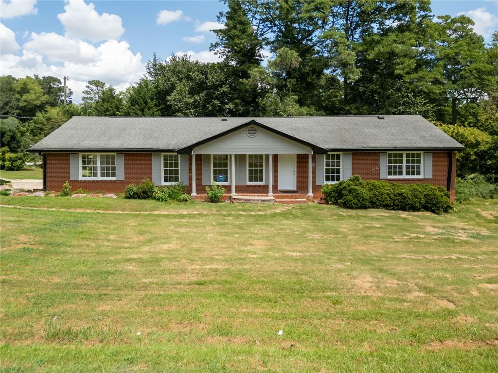 All-Brick Ranch in Marietta – Prime Location Near Schools and Shopping! Welcome to this charming four-sided brick ranch, perfectly situated in the heart of Marietta! This home sits on a spacious corner lot and features a fenced backyard with mature trees—and even your very own fig tree! Inside, enjoy a bright floor plan with updated flooring, stainless steel appliances, and a cozy living room with a whitewashed brick fireplace. Step out onto the covered back patio and enjoy peaceful mornings or relaxed evenings in your private yard. Whether you're looking for a primary residence, a long-term rental, or an Airbnb opportunity, this home offers excellent potential as an income property. Close proximity to The Battery at Truist Park, you'll love being close to Braves games, restaurants, shopping, and easy highway access.