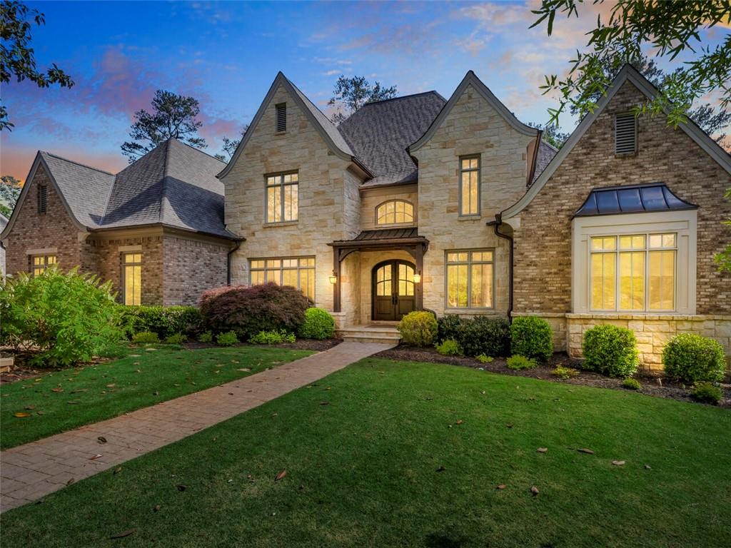 This finely crafted custom home commands attention with a thoughtfully curated mix of distinctive architectural elements. Eye-catching attention to detail blends refined elegance with an intimate warmth highlighted through the use of reclaimed wood accents, intricate millwork, custom limestone mantles and iron doors. Lofty ceiling heights and abundant natural light create an inviting main level centered around the exceptionally well-equipped kitchen adjoining the spacious living room open to a spectacular fireside-covered patio overlooking the stunning backyard with a large stone sun deck, heated saltwater pool and pool house with outdoor kitchen. The expertly finished terrace level features a private guest suite, home theatre, workout room and expansive wine cellar with seating.